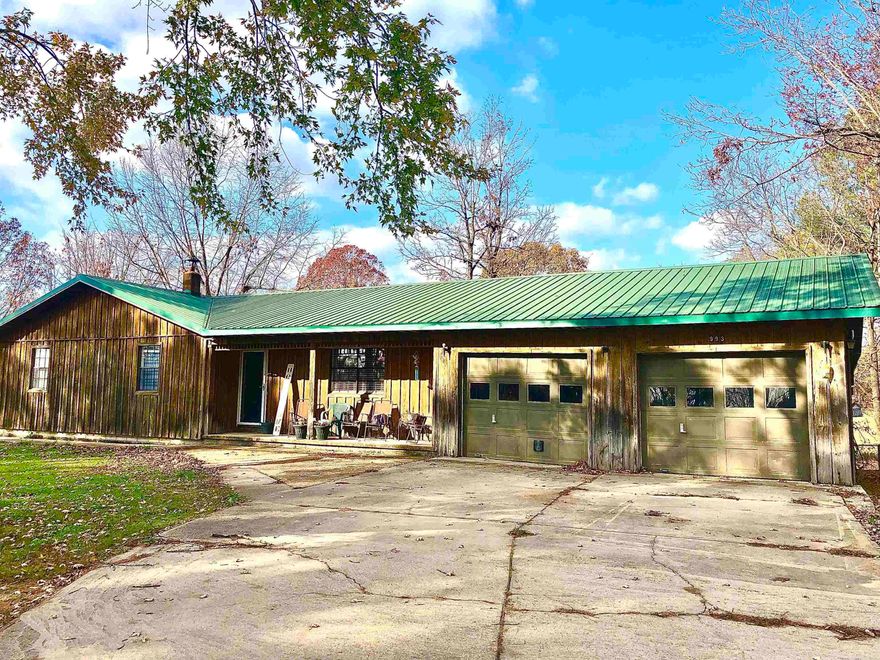 This charming rustic home, set on 6 picturesque acres, offers a peaceful retreat with modern conveniences. The 3-bedroom, 2-bathroom house features a spacious screened porch, perfect for relaxing and enjoying the serene surroundings, and a 784-square-foot basement, providing extra storage or versatile space for your needs. The property boasts a mature fruit orchard and fenced acreage, offering both beauty and functionality for outdoor enthusiasts, gardeners, or animal lovers. A chain-link fenced yard provides a safe space for pets, while a 2,000-square-foot metal shop offers ample room for hobbies, storage, or business needs. Surrounded by beautiful open land, this property is ideal for those seeking tranquility and the charm of country living.