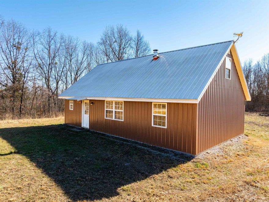 If you’ve been searching for a rare piece of the Ozarks—where privacy, views, wildlife, and a turnkey cabin come together—this incredible property delivers. Perched high on a hilltop with breathtaking long-range views, this 2025-built cabin sits on approximately 30 acres of prime Ozark land. From this elevated setting, you truly are where the eagles nest, surrounded by peace, privacy, and stunning scenery. The cabin features two bedrooms, one full bath, one half bath, a comfortable living room, dining area, full kitchen, and laundry area. A wood-burning stove adds warmth and charm, while central heat and air provide year-round comfort. A loft area offers additional sleeping space, allowing the cabin to comfortably sleep up to eight. Inside are tongue-and-groove wood walls, vinyl flooring, a metal roof, electric stove, and refrigerator. The home is served by well water and Entergy electric and was built by the sellers. Outside, you’ll find a shop with a large roll-up door, plus the seller is leaving a Kubota tractor with attachments, including a backhoe, front-end loader, bushhog, and lawnmower—making this property truly turnkey. The land offers mature timber, caves, and more!
