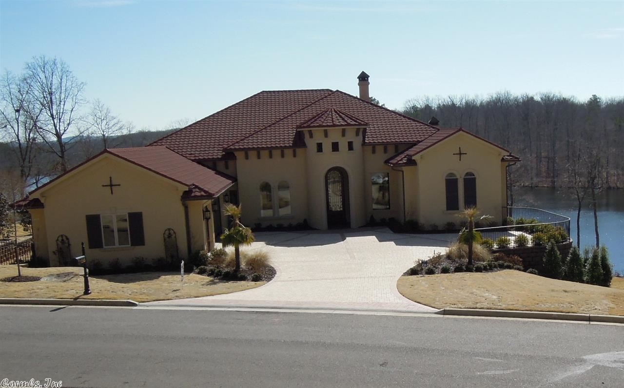 Mediterranean Style lake home. 4 bdrms 5 1/2 bths, custom designer kitchen includes Jenn aire 6 burner stove w/grill, granite countertops, ice maker, refrigerator.  Master bedroom suite w/stunning wood vaulted ceilings, oversized closet & custom designed shower.  All bedrooms have private luxurious baths, heat/air zoned for each living & bedroom areas.  Professionally landscaped with over 200 ft lake front.  Dramatic salt-water infinity pool surrounded  by lush landscaping and decorative pavers.
