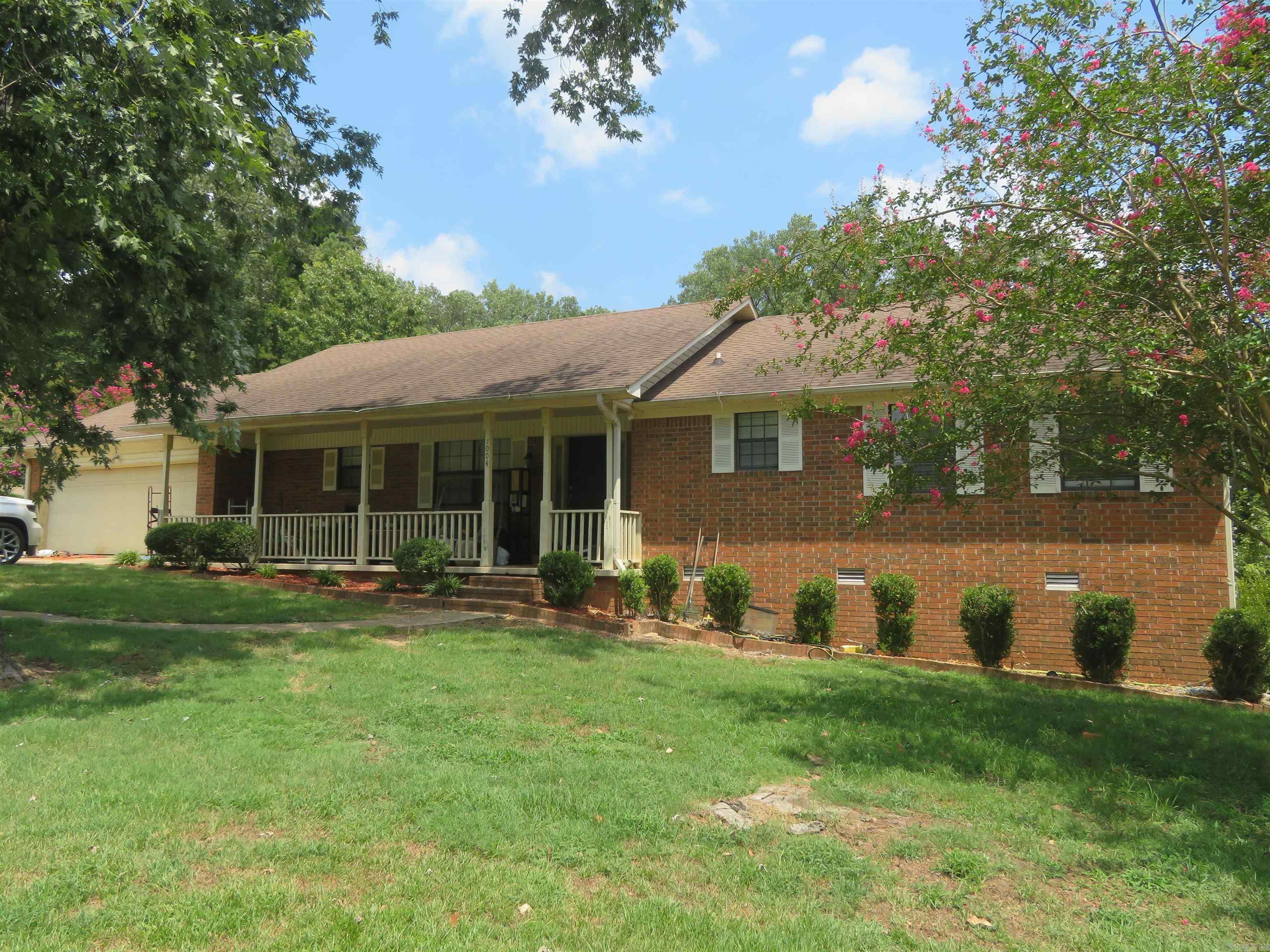 TRADITIONAL, 1-Level, BRICK HOME with nearly 1,800 sq. ft., heated/cooled --- PLUS an 8' x 32' covered FRONT PORCH & a DOUBLE GARAGE WITH STORAGE/SHOP AREA measuring a total of 21' x 29'. And there is a HUGE SCREENED PORCH on the rear (East side) of the house measuring nearly 10' x 32'! This screened porch COULD BE enclosed with windows and/or exterior siding --- & install a subfloor with hard-surface flooring (presently has a treated-pine, deck floor). A Buyer MAY WISH to make this area heated/cooled. There is also an open-air, smaller deck (approx. 12' x 12'). This residence is ON A CORNER LOT and the most recent occupant required additional off-street parking --- so there are 3 ADDITIONAL, GRAVELED AREAS for 'EXTRA PARKING'. The interior is mostly newly painted (pale grey & white) and has new, 'waterproof' Vinyl Plank Flooring in shades of gray. The kitchen has lots of custom-built cabinetry, an adjoining/adjacent CASUAL DINING AREA, and a separate LAUNDRY ROOM and HALF-BATH. Large LIVING/DINING COMBINATION (with doorway to huge, 'screened' porch). There are 3 BEDROOMS & 2 BATHS (plus the half-bath). Newer Architectural Shingles installed less than 10 years ago.