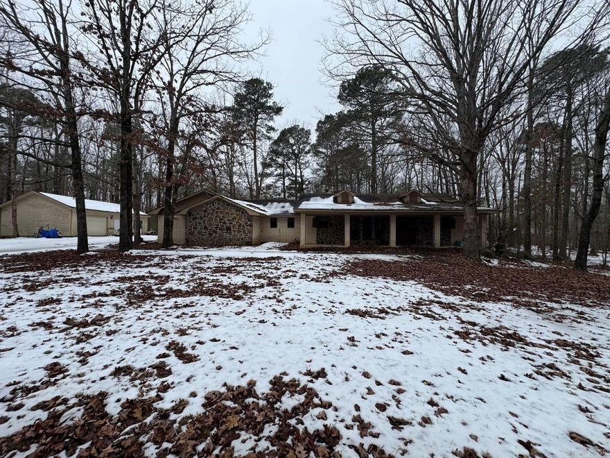 This home offers a comfortable living room with a stone wood-burning fireplace insert and a versatile den/bonus room located in the garage attached to the home. While the property requires renovation and is being sold as-is, it boasts numerous desirable characteristics garage/workshop, a barn, and additional outbuildings, providing ample space for storage, hobbies, or future use. Mature, picturesque trees surround the home, creating a private and serene setting. Previous foundation repairs have been completed, and the seller will convey a transferable warranty.  See Agents Remarks