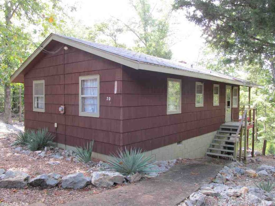 Great get away place! Quiet setting with lots of room to stretch out. Located on a  cul-de-sac for privacy this older, rustic cabin is ideal for a great away place. Designed for efficiency w/wood burning   fireplace, small den or third sleeping area and a covered deck. This price includes two (2) additional Cherokee Village lots. Priced to sell quickly.