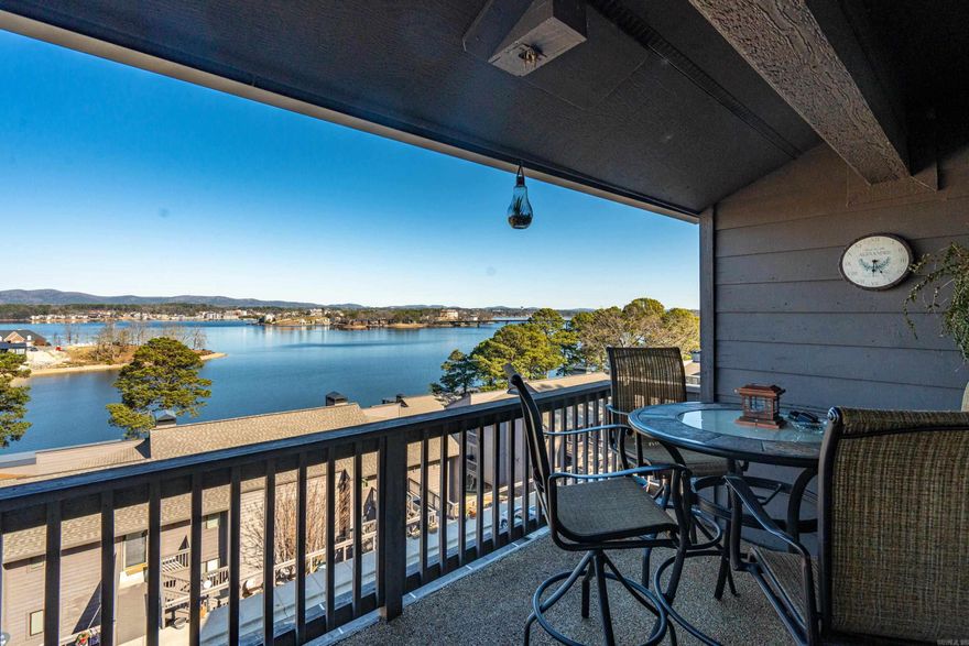 Amazing Main Channel Lake View! You will have the best seat on the lake looking at the big Lake Hamilton views and a front row to thelake fireworks. This fully furnished, 2 bedroom, 2 bath condo is ready for a new full time resident, a weekend get away or as aninvestment property used for nightly rental income. The kitchen is open to the dining area and living room, which offers large floor toceiling windows showing those big lake views, opening to the deck. Primary bedroom ensuite also offers a lake view and access to thedeck. This is a top floor condo, however there are only a few steps to the front door. A second deck off of the dining area is perfect foryour grill. Assigned parking at the front door makes for easy access. Make this condo yours now to starting living the Lake Life!