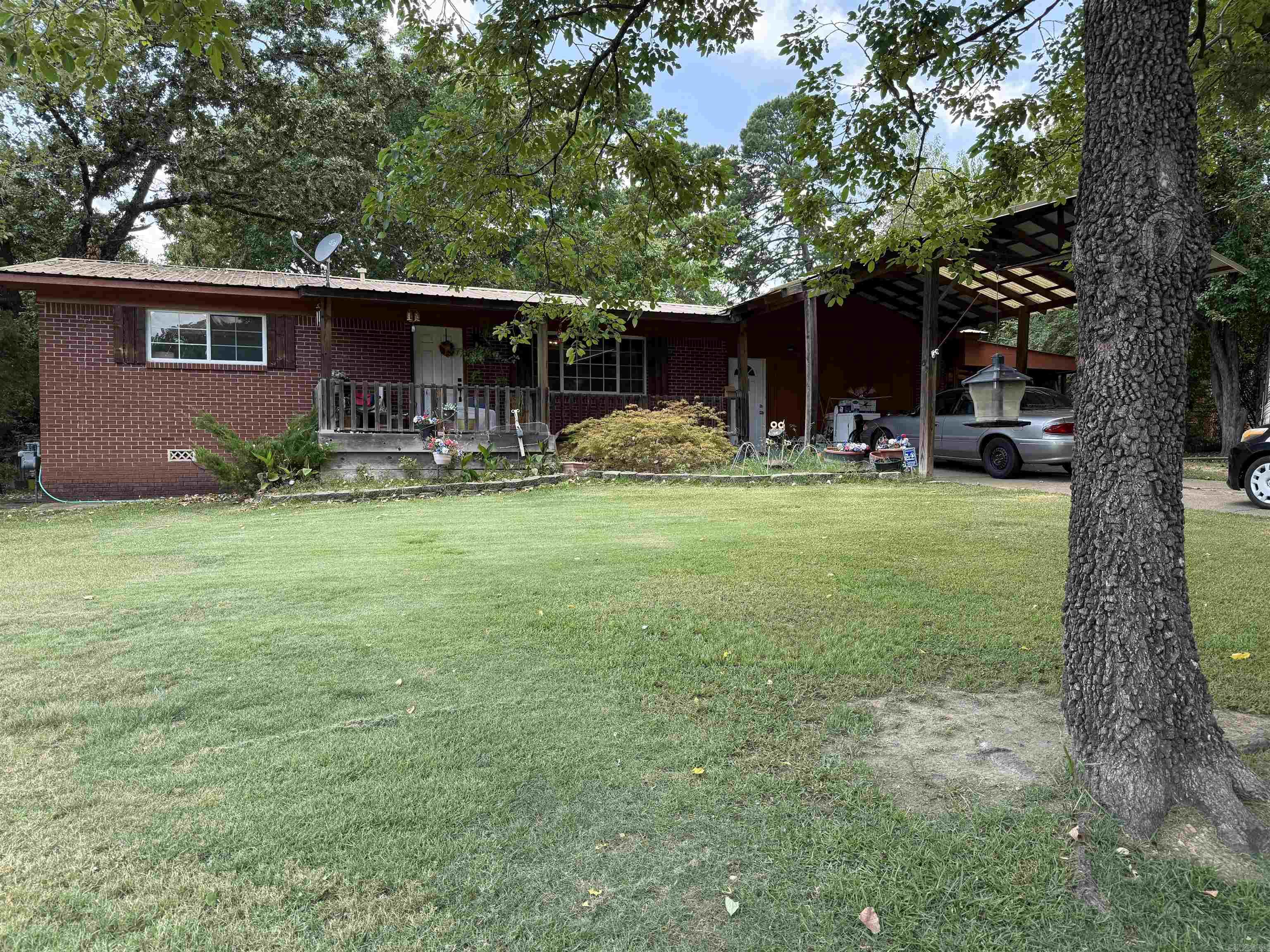 Larger home on beautiful lot close to everything! Several updates in past 5 years including flooring, gorgeous skylight in kitchen, crown molding, newer double pane windows. The master suite has a wonderful dressing room area and newer shower. Sunroom looks out over the back yard where you find a storage building with utilities and a fully fenced back yard. There is a lean-to shed to store all your yard supplies. Fruit trees are everywhere including pear, peach and fig! Sunroom is not included in courthouse square footage but is heated and cooled! Washer, dryer and fridge in shed convey along with window a/c unit in shop. gray storage building does not convey. There is a chimney in sunroom if you wanted a wood or pellet stove!