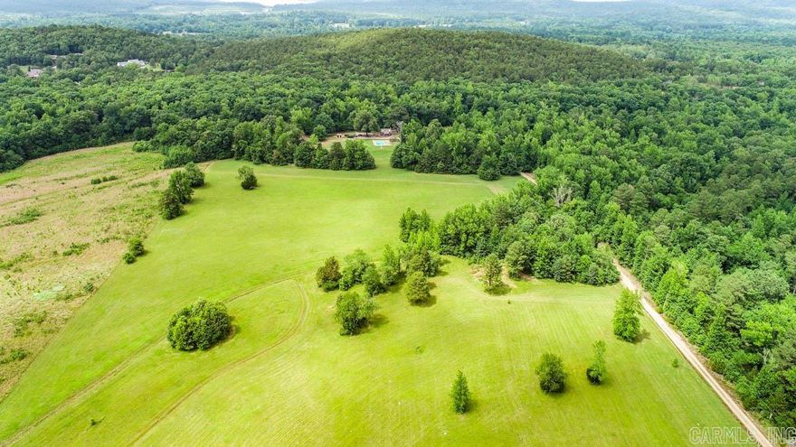 Gorgeous level land with pasture and woods. Kinley Creek flows across the back section. Cozy 550 sq ft cedar cabin with a loft bedroom, screened in porch, fireplace, kitchen, and living room. Well and Septic are already in place.  There is an  in-ground pool. Barn/shop with pit for changing oil, overhangs for hay and tractor storage. Public water is available.  No restrictions. Agents see remarks.