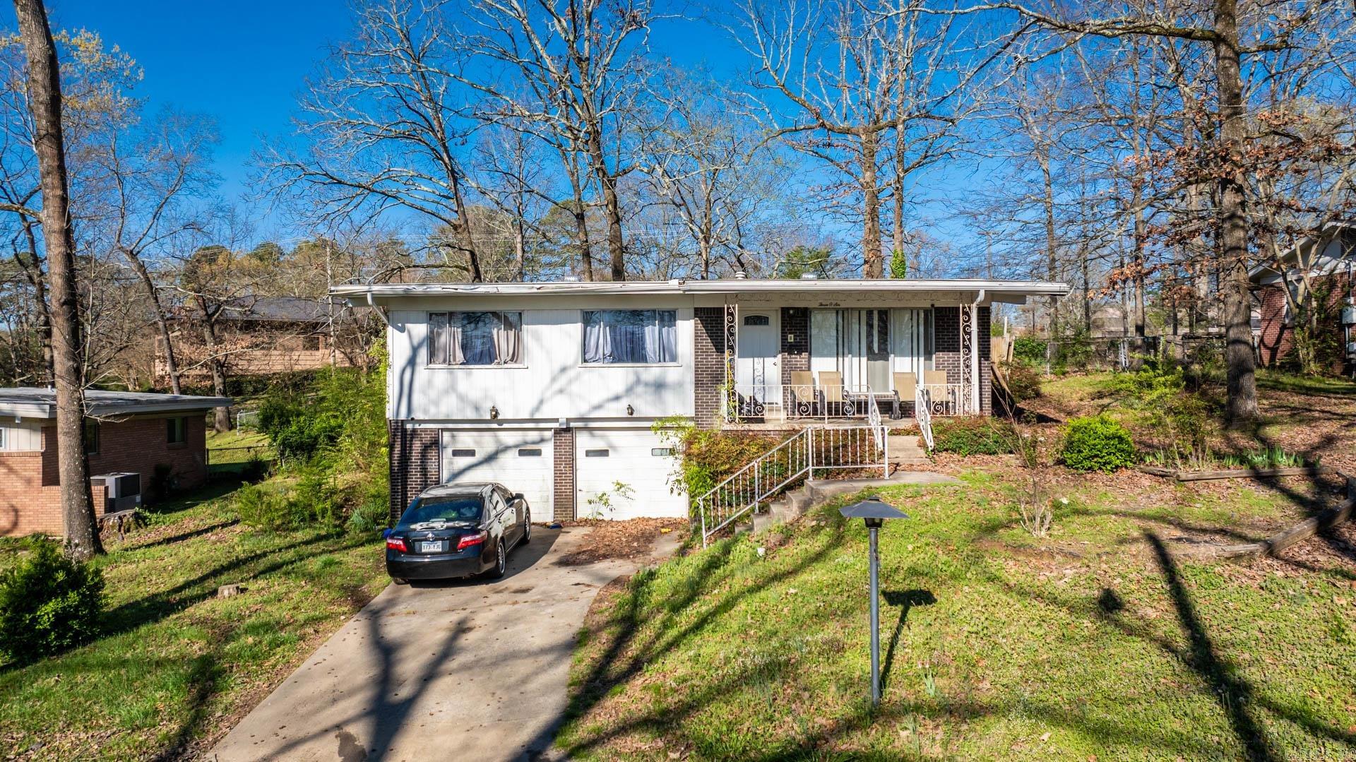 This wonderful 3 bedroom, 2 bathroom home tucked on a no-through street in the heart of Little Rock offers a combination of easy access to Downtown, Midtown and West Little Rock. You are welcomed in the living room with a fireplace and natural light from the big windows. Your eat-in kitchen has an island for extra storage and counter space. Down the hall is a full bath, 2 bedrooms and the primary suite with full bath. Downstairs is the washroom and 2 car garage. The spacious backyard is great to host your outdoor enjoyment.