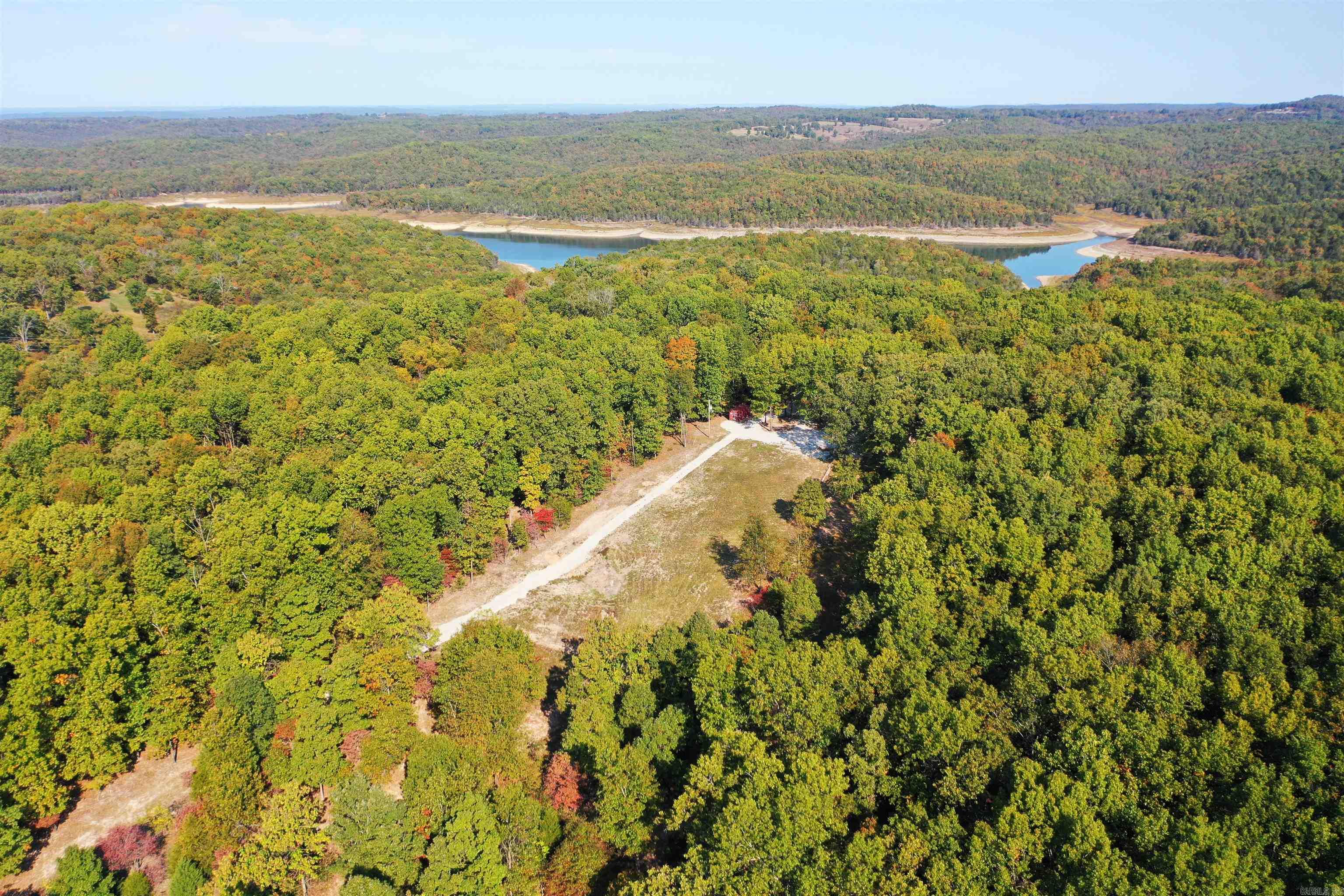 THIS AMAZING UNRESTRICTED PROPERTY OFFERS YOU SO MANY WONDERFUL OPTIONS. BUILD YOUR DREAM HOUSE, OR PARK YOUR RV AND HOOK UP TO ALL THE UTILITIES AND ENJOY THE LAKE LIFE. THIS 5.85 AC/ML LOT ALREADY COMES WITH A 3 BEDROOM SEPTIC SYSTEM, ELECTRIC, WITH A 50 AMP HOOK UP, NEXT INTERNET, PRIVATE WELL. ALSO, ASSOCIATION WATER IS AVAILABLE TO HOOK UP TO AT THE ROAD. BULL SHOALS LAKE ACCESS IS ONLY AROUND A MILE FROM THE PROPERTY & WHITE RIVER ACCESS IS NOT FAR AWAY AS WELL. THE LOT FEATURES PLENTY OF HARDWOOD TREES AND NICE PASTURE LAND IN THE BACK, PLUS A WET WEATHER CREEK. THIS ONE IS A RARE OPPORTUNITY. COME CHECK IT OUT.