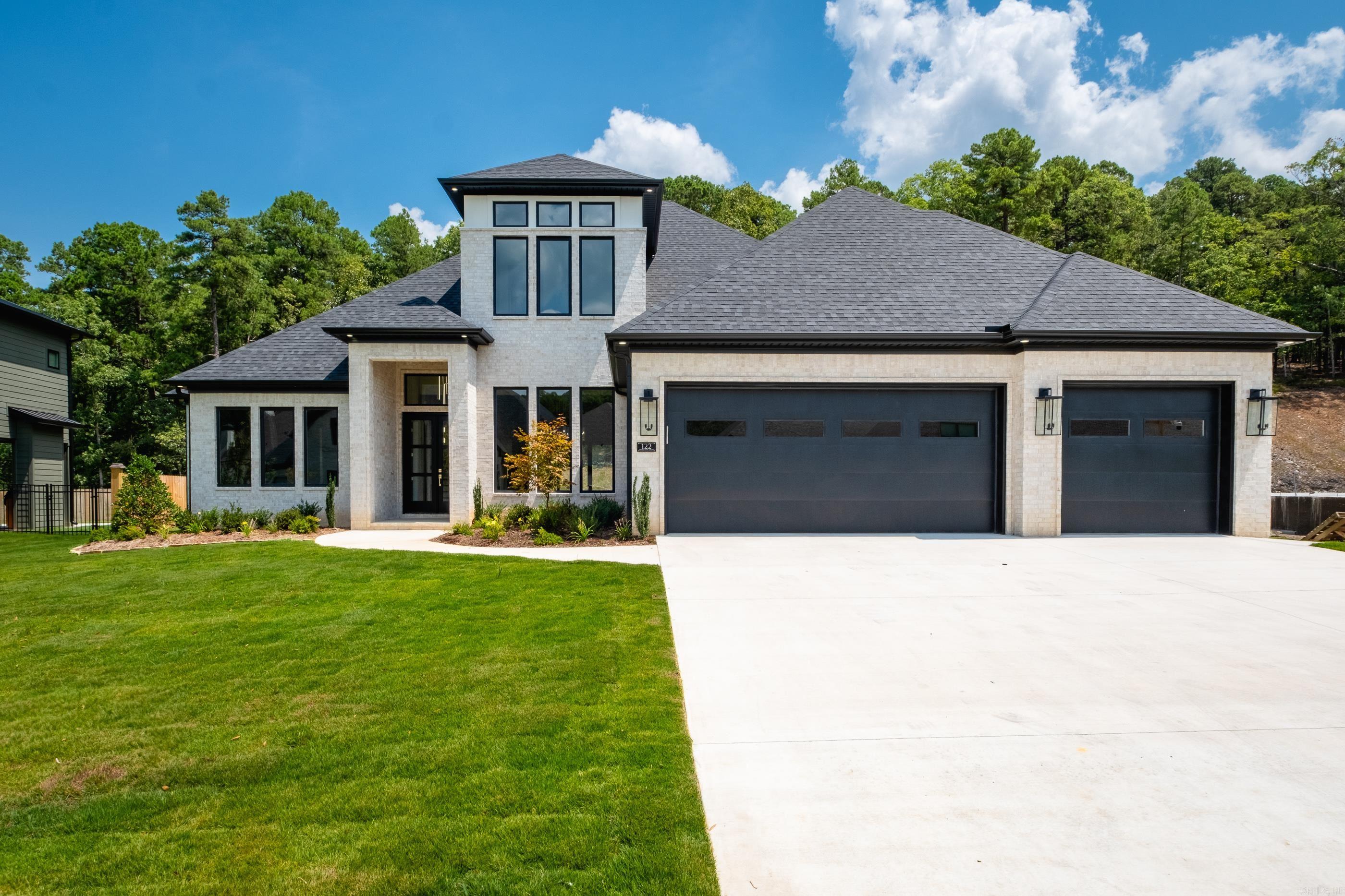 Welcome to 122 Abington Drive, a stunning light-brick home with bold black windows, striking landscaping, & timeless curb appeal. Step through the grand black front doors with oversized windows & into a space filled with natural light, custom ceiling lighting, & an open floor plan designed for both comfort & entertaining. The heart of the home is the spacious kitchen, featuring double ovens, abundant cabinetry, a walk-in pantry, & built-in glass display cabinets. Timeless light fixtures & fans accent the home throughout, while custom built-ins add both character & functionality. The primary suite is a private retreat, complete with its own fireplace, a spa-like bathroom with a huge walk-in shower, a relaxing soaker tub & split vanities with elegant gold finishes. For added convenience, the primary connects directly to the laundry & mudroom. Downstairs, youāll also find a Jack & Jill bathroom shared by two bedrooms & an additional bedroom with its own private bathroom. Upstairs, in addition to a bedroom and full bath, a large bonus room provides the perfect space for a media room or playroom. Outdoor living is a true highlight with a patio, fireplace & grill.