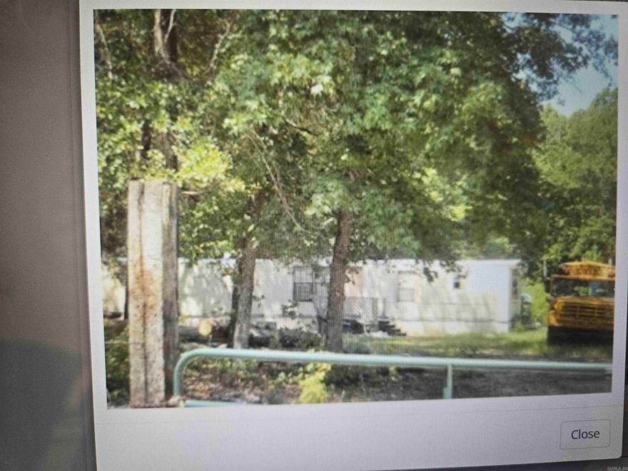 3.15 acres with highway frontage. Some utilities on property. Great chance to own land with no restrictions. School bus will be removed prior to closing. Mobile home is over the boundary line by 17.6 feet.  Buyer will need to move that fully onto the property. Survey flags are up and current survey on file. Partially cleared and partially wooded. Go take a look and call for any other info!