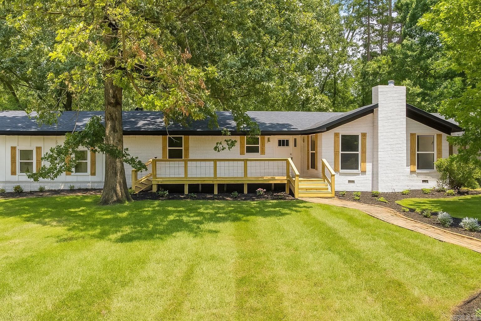 COMPLETE REMODEL ON VERY PRIVATE ACREAGE! This one level property was stripped down to the studs and everything completely replaced, including but not limited to the sheet rock, electrical, plumbing, HVAC, Roof, Windows, Doors, Interior and Exterior paint, Flooring, Lighting, Showers, Countertops, Decks, Fence, you name it! The hardwood floors are real wood and stunning. Custom Tilework for each tub and shower. Open kitchen with large breakfast area and open to living room with beautiful brick hearth and wood burning stove. The Primary suite features double vanity and large walk in closet. Heated and Cooled Sunroom would make perfect office, art studio, or playroom. Spacious Laundry room! Private lot with hardwoods, sitting in the back of a cul-de-sac. Bryant Schools!