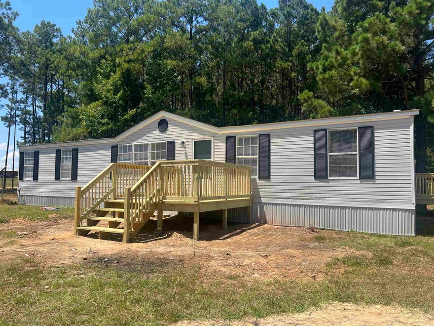 If you are looking for a little privacy, but still close to town.... look no further.  This beautifully updated 4BR, 2BA home is waiting for you to pick up the keys.  Sitting on just under 3 acres, this home has a new roof (08/2025), new floors, new cabinets, countertops, appliances, new bathroom vanities, shower doors, and ceiling fans.  The inside has new paint, and 2 amazing decks have been added to the main and side entrances. The property also has a detached carport and storage building.