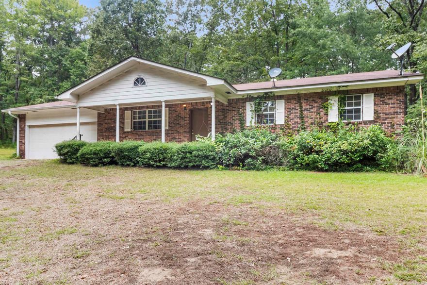 Solid home just needs a little TLC sits on 15 acres with multiple buildings.