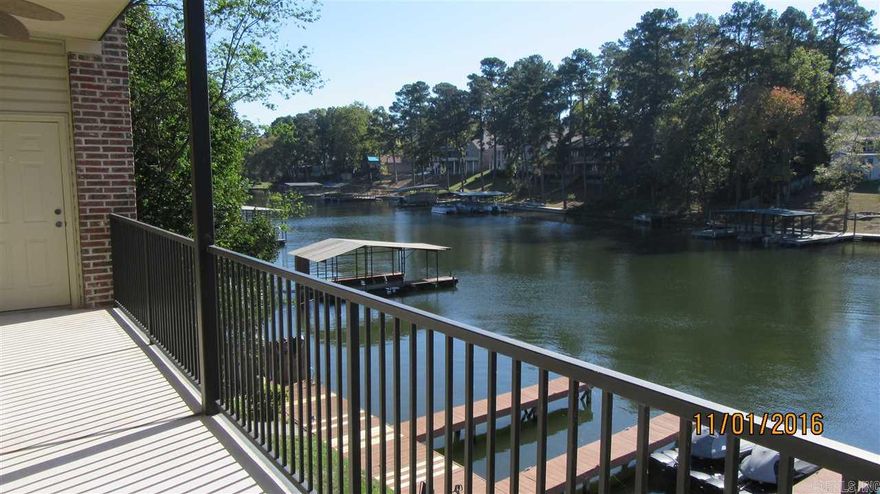 Very Nice Luxury Condo on Lake Hamilton is walk in unit! Close to everything like Marina, shopping and many restaurants! Just a few minutes to Oaklawn!  Loaded with Granite counters in kitchen and full SS appliances including separate ice-maker by sink, brazilian cherry hardwood floors, tall ceilings and crown molding throughout! Access to covered balcony from living and master bedroom! FP has gas logs. Boat slip is included in price!! Very nice condo! Open Floor Plan.  Laundry Room with washer and Dryer!