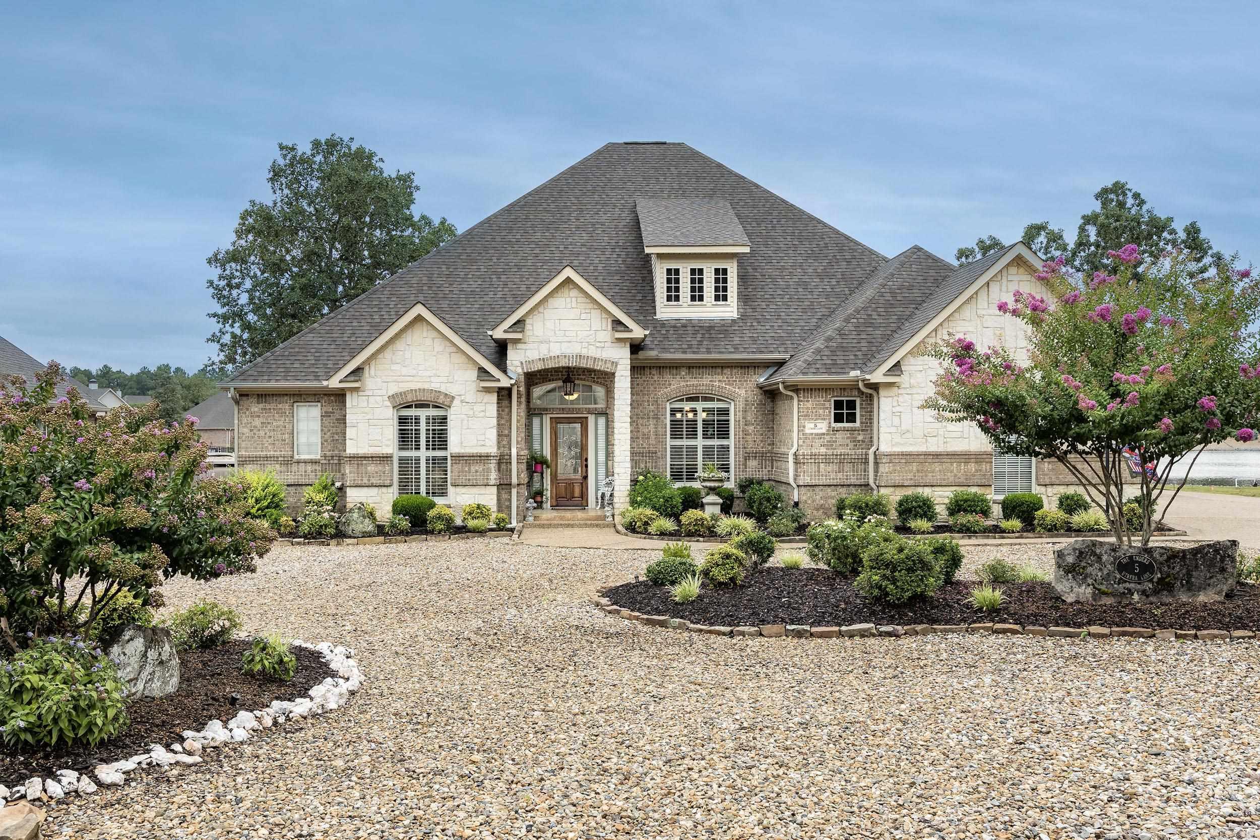 This charming lakefront home beautifully combines elegance with style, featuring a brick exterior, stone accents, large windows, 3 car garage, and a welcoming entrance. Inside, the spacious layout is bathed in natural light, offering stunning lake views. It includes a dedicated office, a formal dining room, walk-in closets, and custom built-ins. This traditional 3-bedroom, 2.5-bathroom residence is ideally situated on the desirable east side of Hot Springs Village, set on a professionally landscaped, level lot with a dock. The paddle boat and kayaks will convey, a home warranty is available. Donāt miss your chance to tour this immaculate home on Lake Mariaācall today to make an appointment. Showings are by appointment only; please refer to agent remarks for details.