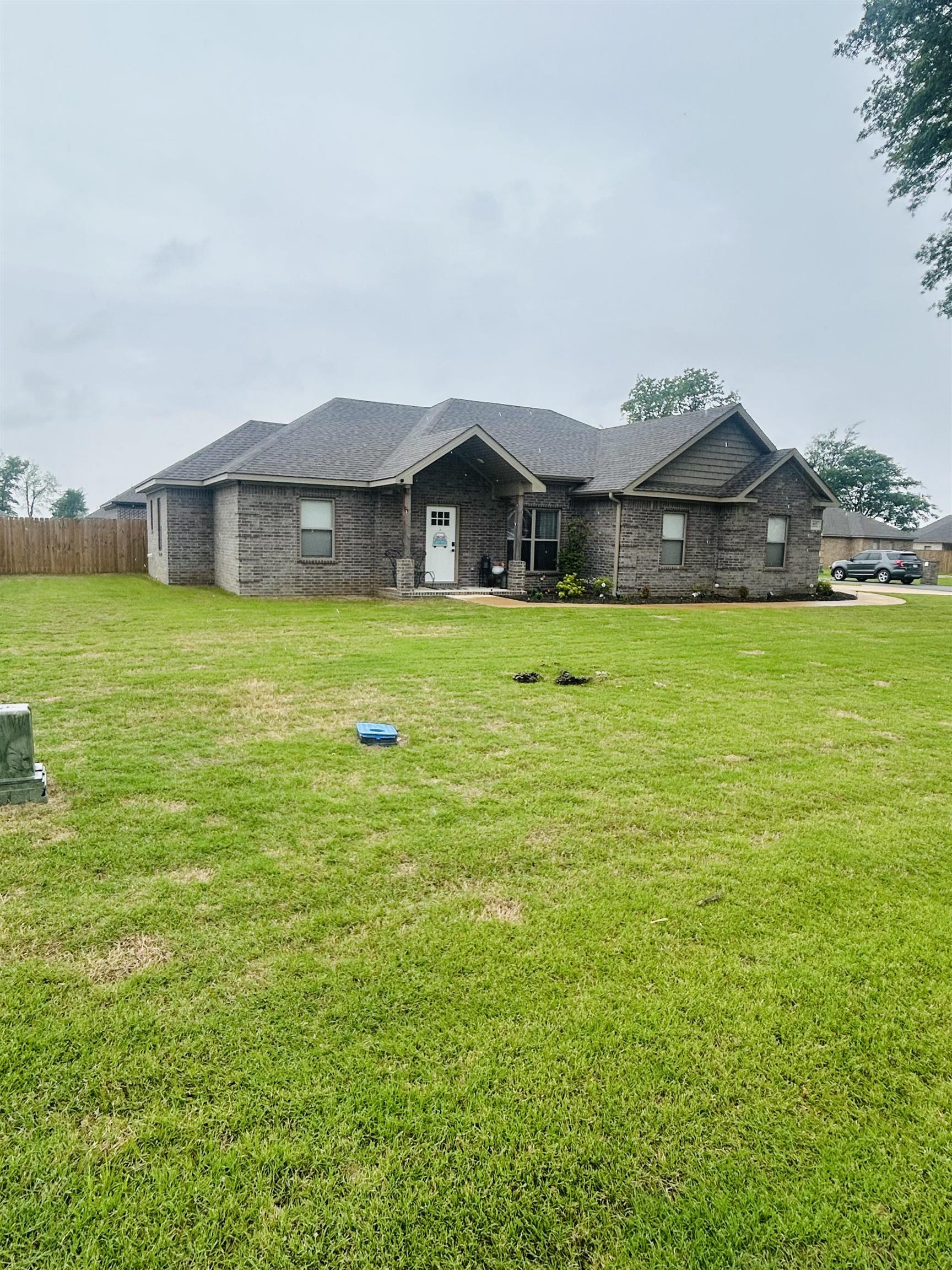 This beautiful 4-bedroom, 2-bath home is perfectly situated on a desirable corner lot in a well-established neighborhood. Step inside to discover a bright and airy open floor plan that seamlessly connects the living, dining, and kitchen area—ideal for entertaining or enjoying everyday family life. The spacious kitchen, featuring modern appliances—all of which convey, including the washer and dryer. You’ll love the ample cabinetry, generous counter space, and an island that overlooks the main living area, making it the true heart of the home. Retreat to the private master suite, complete with a generous walk-in closet and a luxurious en-suite bathroom showcasing a large walk-in shower with elegant tile finishes. Enjoy outdoor living year-round on the screened-in back porch—perfect for morning coffee or relaxing evenings. The landscaped yard offers added privacy and exceptional curb appeal, thanks to the premium corner lot. Additional highlights include professionally landscaped front yard, a built-in underground drainage system that protects sidewalks and flower beds from overflow, and thoughtful design touches throughout. Don’t miss your chance to call this warm and inviting ho