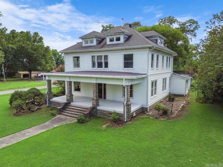 Step into timeless elegance with this charming historic gem nestled in the heart of Atkins. Built in 1860, this 5-bedroom 1.5 bath home beautifully blends character with room to add your own updates. From the moment you enter, you are welcomed by a grand foyer featuring an elegant oak staircase that showcases the craftmanship and charm of a bygone era. Relax and unwind on the spacious front porch, perfectly positioned on a corner lot to enjoy the small-town charm. Additional outdoor storage buildings provide ample space for tools, hobbies, or extra storage needs.  Don't miss your opportunity to own a true piece of Atkins history-a home filled with character, space, and endless potential.