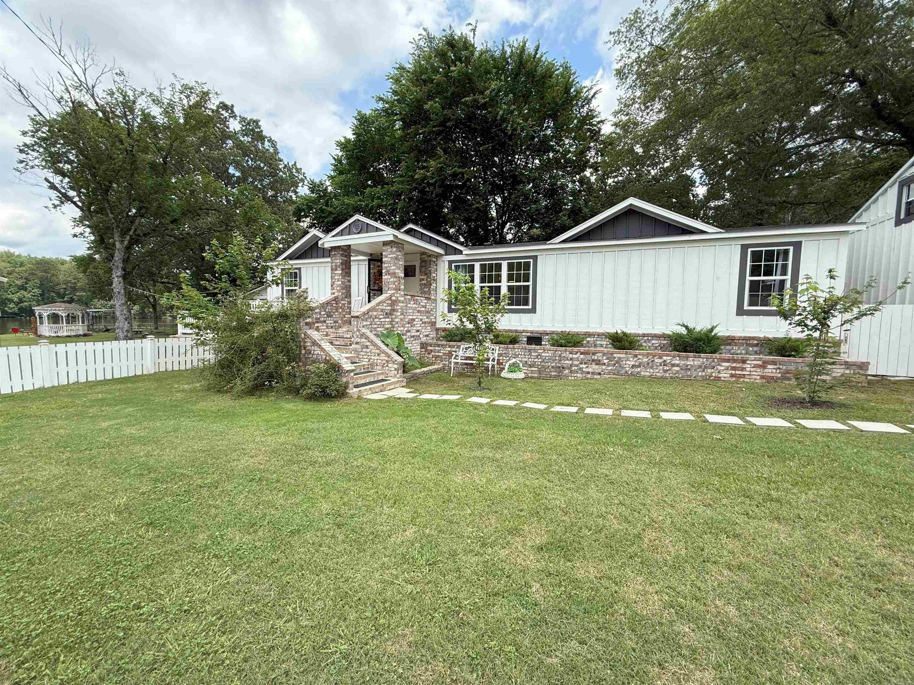 Rare lakefront home with its own boat launch! This 3 bed, 2 bath home offers the perfect mix of comfort, style, and lake life fun. Enjoy your own private boat launch, boat dock with swim deck, and a large covered porch—perfect for morning coffee or winding down after a day on the water. Inside, you'll love the cozy, well-decorated interior that could sleep 8–12 with the right setup. There's plenty of parking and even extra property across the street with potential for a tiny house and lake view. CURRENT APPRAISAL & FURNITURE can be included with an accepted offer (some personal items excluded). Whether you're looking for a weekend retreat, full-time residence, or vacation rental, this adorable lake house checks all the boxes!