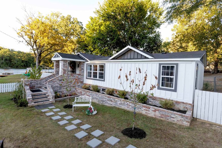 Charming lakefront getaway! This 3 bed, 2 bath home offers the perfect mix of comfort, style, and lake life fun. Enjoy your own private boat launch, boat dock with swim deck, and a large covered porch—perfect for morning coffee or winding down after a day on the water. Inside, you'll love the cozy, well-decorated interior that could sleep 8–12 with the right setup. There's plenty of parking and even extra property across the street with potential for a tiny house and lake view. CURRENT APPRAISAL & FURNITURE can be included with an accepted offer (some personal items excluded). Whether you're looking for a weekend retreat, full-time residence, or vacation rental, this adorable lake house checks all the boxes!