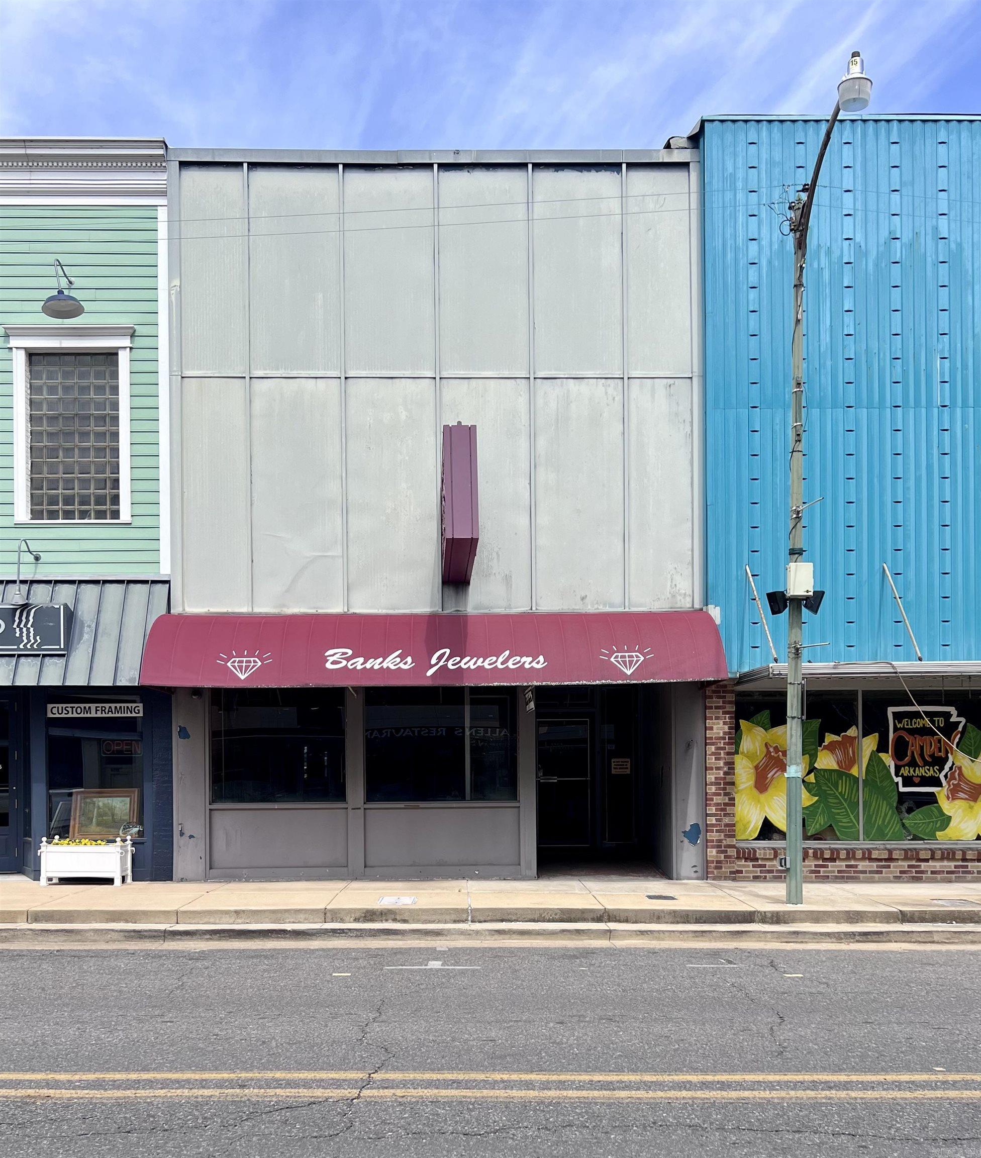 Looking for a prime commercial property in the heart of downtown Camden? This high-visibility building is perfectly situated across from Allen’s Restaurant, guaranteeing foot traffic from locals and visitors alike. With its central location, this property offers an unbeatable opportunity to be part of Camden’s vibrant downtown scene, including the popular First Friday events. Boasting over 2,300 square feet on the main level and an additional 2,300 square feet upstairs, the possibilities are endless! The lower level can be transformed into retail space with just a few updates, while the upstairs currently serves as warehouse space. Want to dream bigger? Envision a complete remodel with chic apartments upstairs and retail or office space below, maximizing your investment potential. This property is listed AS IS, providing ample room for updates tailored to your vision. A recent 2024 appraisal is available for informational purposes upon request. Buyers are responsible for obtaining their own appraisal if desired. Cases not attached to the wall and safe to be removed before closing. Seize the opportunity to bring your business or investment vision to life in downtown Camden!