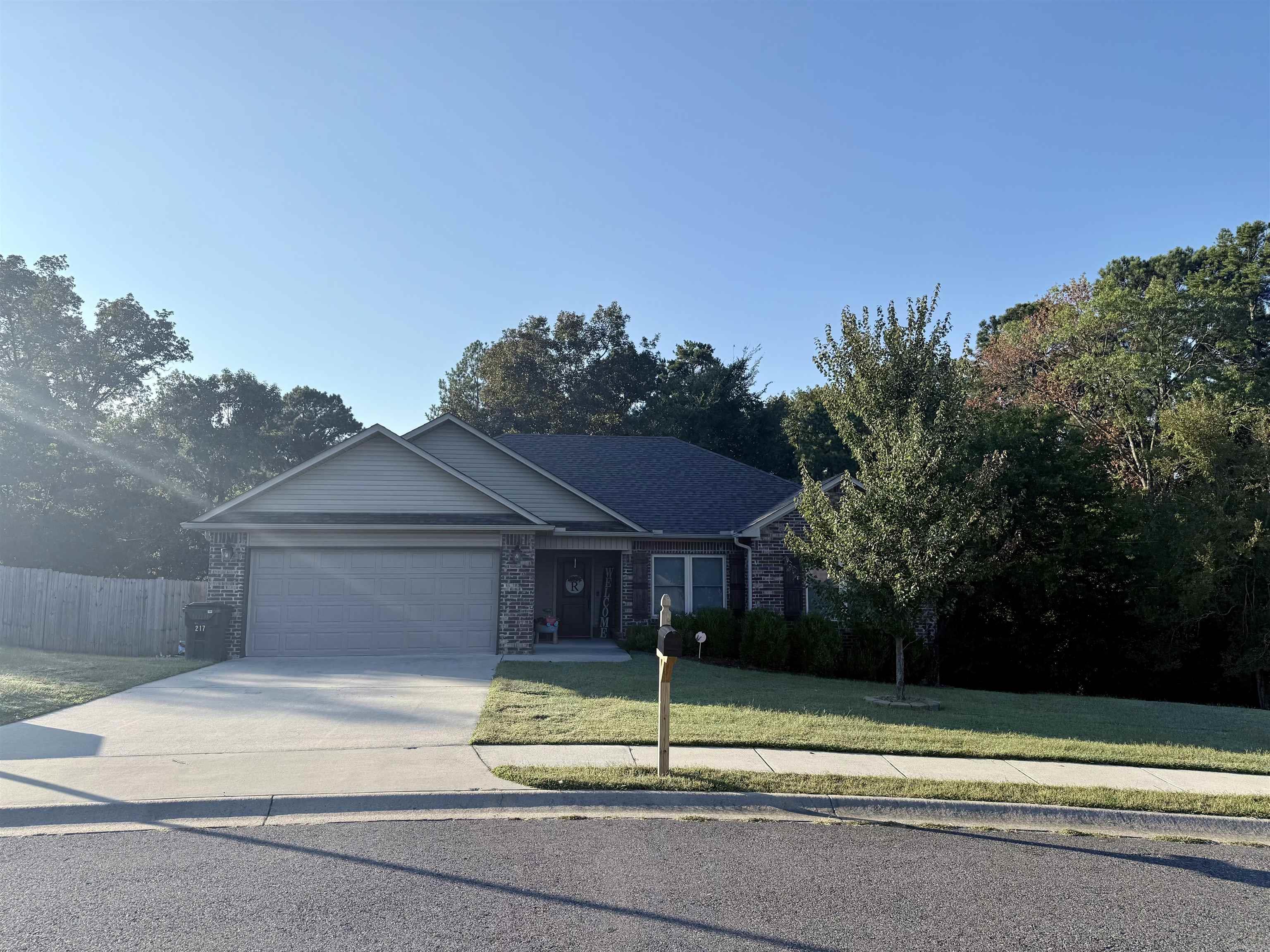 BEAUTIFUL HOME IN HAMILTON PARK SUBDIVISION! This home was built in 2018 with 1,417 sq. ft. One Owner Home. Corner lot with one of the largest backyards in the subdivision. It boasts an open floor plan with the living room featuring a wood burning fireplace with 10' ceiling, hardwood flooring all throughout, wooden blinds, and ceiling fans. Breakfast bar in the kitchen, dark brown cabinets topped with exotic granite counters, can lights in kitchen, large tile flooring, and stainless steel appliances. Exotic granite counters and tile flooring continued in both bathrooms. Two separate walk-in closets in master bathroom. Jacuzzi tub with shower combo in master bath. Linen closet in both bathrooms. Split floor plan. Spacious bedrooms with 8ā ceilings. Covered back deck and fenced in yard. Crawlspace storage. Custom shutters. New roof, gutters, and new Alaskan windows (July of 2023). New steel piers added by a licensed professional (September of 2025). Lake Hamilton School District.