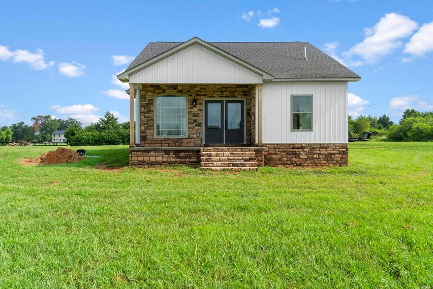 New Construction on Nearly 5 Acres- Tucked outside the city limits, this thoughtfully designed home offers the perfect balance of luxury and rural tranquility on nearly 5 acres. Inside, you'll find 3 generously sized bedrooms and 2 well-appointed bathrooms, designed with both comfort and function in mind. This home features LVP flooring, 2-car garage, and loads of privacy, split floor plan, and more! The expansive kitchen is both functional and inviting, anchored by a center island, offering quartz countertops, ample storage, custom cabinetry, a beautiful backsplash, and outfitted with sleek black appliances. Every finish reflects a commitment to quality, with elevated details and craftsmanship. The living area draws you in with its electric fireplace and hand-picked tile, which adds warmth and charm. The primary suite is an absolute dream and offers unique tiled flooring, a dual vanity, large soaking tub, gorgeous walk-in shower, and a generously sized walk-in closet with shelving. Step outside and take in the peaceful, open views of your own private acreage, complete with a fenced-in area with a small barn ready for your animals! THIS ONE IS A DREAM. Mineral rights do not convey.