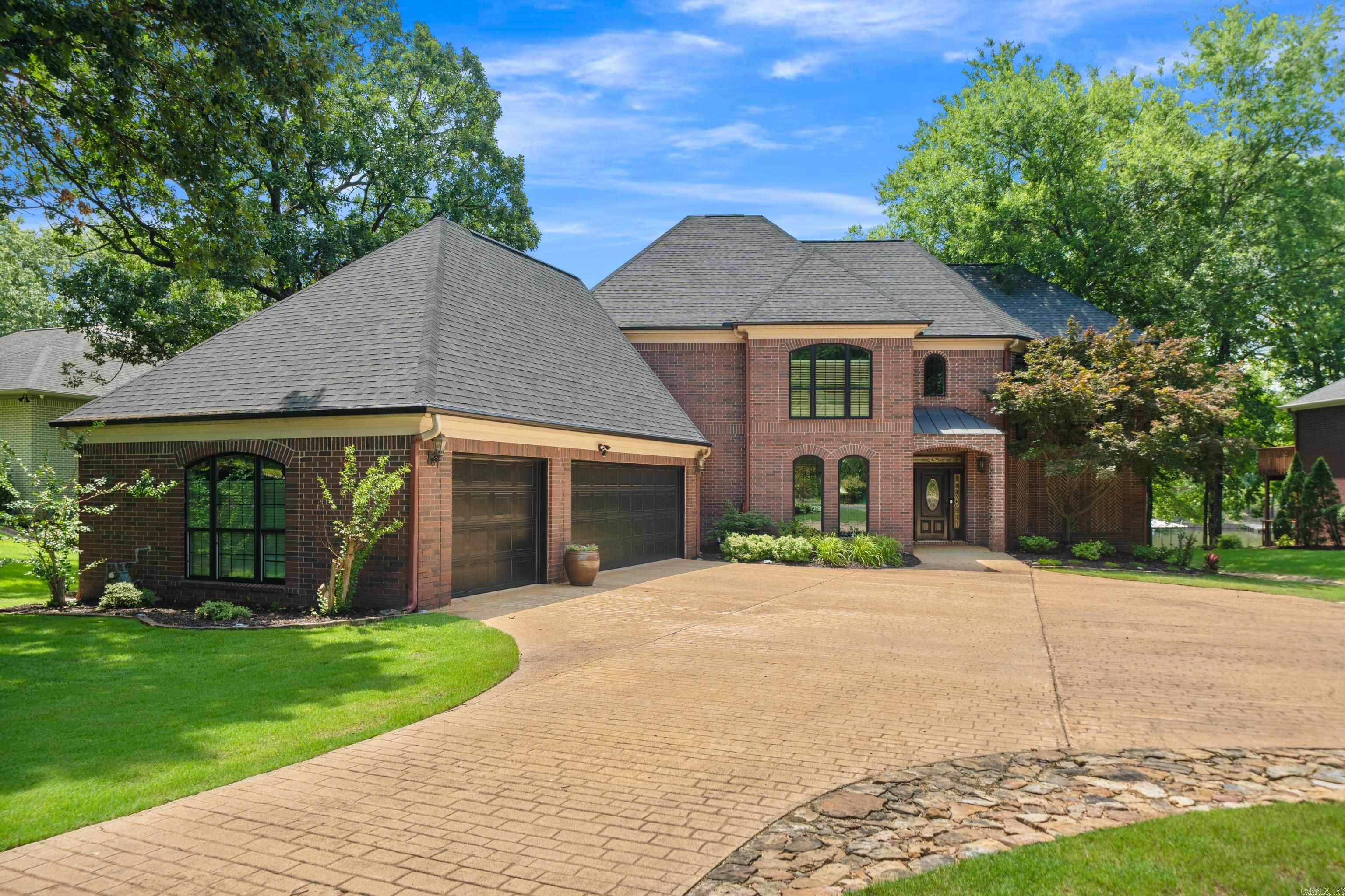 Exquisite Lakeside Living in Prestigious Stonegate Shores! Discover an exceptional opportunity to own a beautifully appointed 5-bedroom, 3.5-bath waterfront estate on the serene shores of Lake Hamilton. Set on a meticulously manicured, level lot in the prestigious gated community of Stonegate Shores, this home blends sophistication, comfort, and the ultimate lake lifestyle. Enjoy a spacious main-level primary suite, formal dining room, great room, separate living room, and a gourmet eat-in kitchen designed for both everyday living and entertaining. An oversized 3-car garage offers plenty of space for vehicles and lake gear. Step outside to your private oasis with a professionally landscaped backyard, tranquil water feature, fire pit, and direct access to a 2-slip covered boat dock in a peaceful no-wake cove with boat launch—perfect for swimming, boating, or simply relaxing. Recent upgrades include new insulated windows and a new roof (Dec 2023). Just minutes from all that Hot Springs has to offer, this is lakeside luxury at its finest! Schedule your showing today!