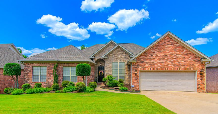 All brick one level home offering 4BR/3BA, formal dining and a dedicated office with custom cherry bookcase. The great room has a lovely interior/exterior gas fireplace and wet bar. The owner’s suite includes an en-suite bathroom with a soaking tub, walk-in shower and fireplace. The open plan kitchen has a new gas stove and granite countertops, opening into the hearth room with fireplace, making this area perfect for gatherings. Custom cabinets and crown molding throughout, including travertine in bathrooms. Beautiful authentic hardwood floors completely redone in April 2024 (including owner’s suite). Additional amenities include a deck with an exterior fireplace and gas grill connection, a laundry room, sprinkler system, two car garage, large storage area under house, roof 2018, HVAC 2019, water heaters 2021 & 2024, custom built bookcase in greatroom conveys. There is so much more to this special home you just have to come see. The kids will love that it is within walking distance of the Chalamont pool and park.