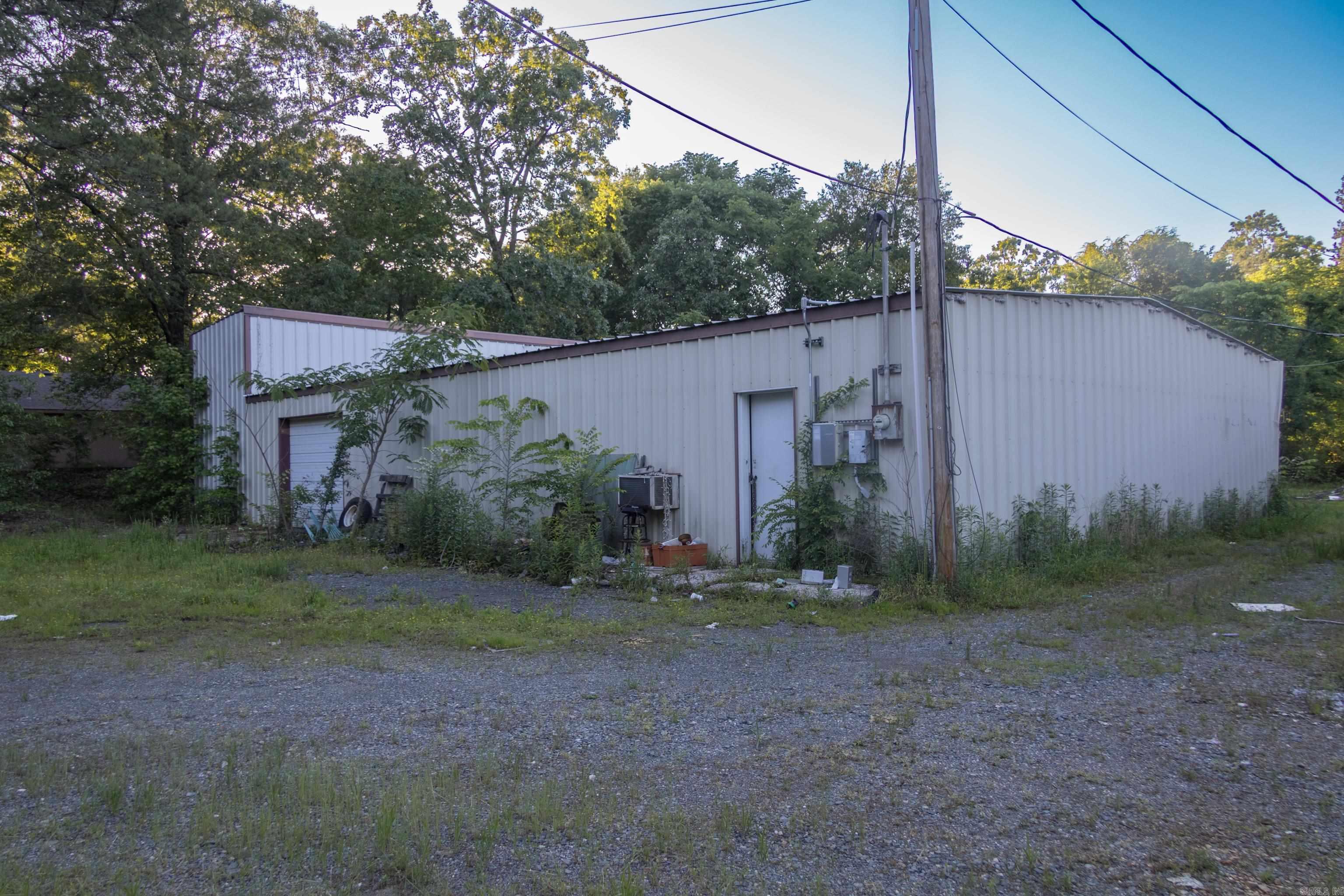 Highway 4 Frontage, 2 acres and a huge metal drive-thru shop!! 2800 square feet for storing your side by sides to ride all the National Forest Trails. This property has been appraised and is priced to sell! There is a large Pond with beautiful flowers in front and the super large shop in the middle, multiple large carports for storage in the rear. The older mobile home has a roof over the entire structure with a covered porch area, it conveys at no value (no title). Half a mile to Scotty's. This won't last long!!