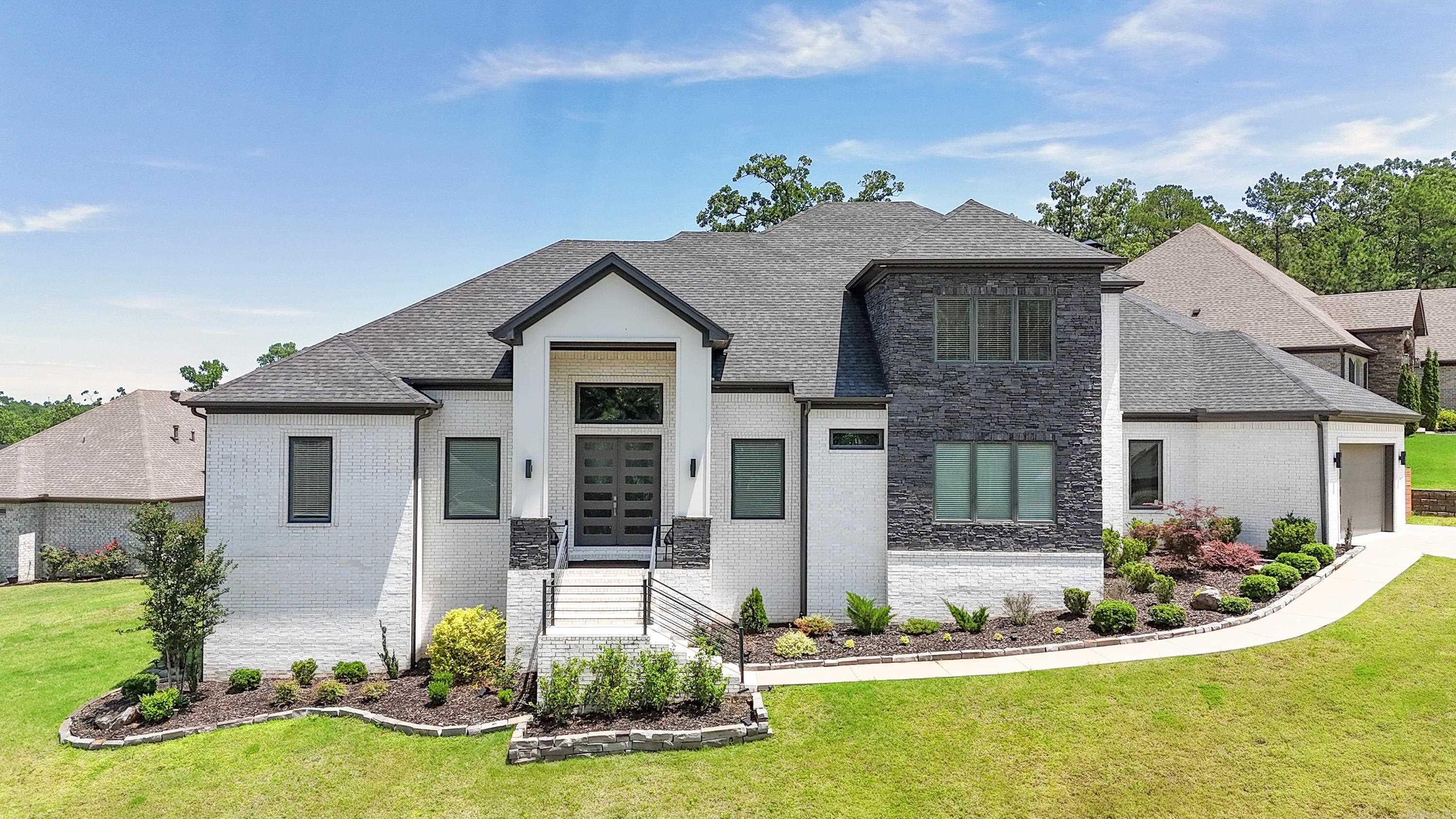 This stunning custom home, built in 2019 on a 0.51-acre lot, offers upscale living with thoughtful design. The main level features a spacious primary suite with a luxurious bath, dual vanities, multiple shower heads, and a huge walk-in closet with built-ins. A guest bedroom with en-suite bath, office, and formal dining room complete the layout. The chef’s kitchen includes a gas range, pot filler, double oven, two dishwashers, built-in microwave, and large pantry. Downstairs offers a bonus room with kitchenette—great as a media room—plus storage and access to a second garage. Upstairs are two more bedrooms with private baths and walk-in closets, along with a large bonus room and projector. The oversized 3-car garage includes a Tesla charger. Enjoy the covered patio with fireplace and outdoor kitchen, or relax on the extra concrete patio space. This home truly has it all—schedule your private showing today! Building plans available. Agents see remarks