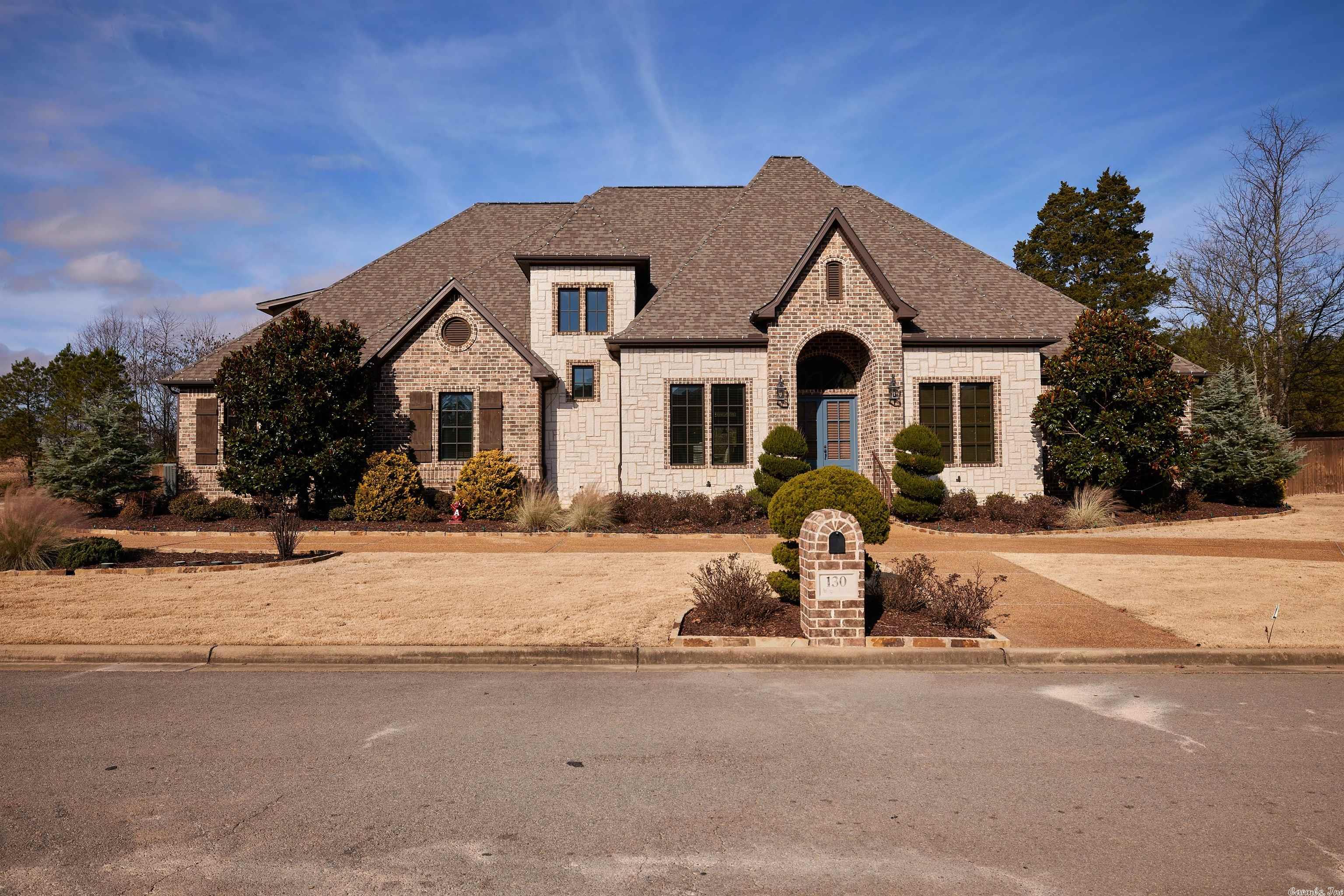 Arlington Park is home to many beautiful estate properties, and 130 Arlington Park Court rises above the rest. This dazzling 4 bedroom 4.5 bath home is located on a verdant golf course of the Hot Springs Country Club. Generous living space with stylish finishes. You'll enjoy a lavish setting for both relaxing and entertaining. Hardwood floors in main areas and plenty of natural light flow throughout the homes' open, airy layout. The gourmet kitchen will inspire your inner chef with stone counters, large center work island, and gorgeous custom cabinets. Plenty of parking with a circle driveway and an oversized 4 car garage. Enjoy the low maintenance swimming pool and backyard! Refrigerator: 2021 Kitchen Refresh, Landscaping Refresh, Dishwasher, New Fence Gates: 2022 Spa Heater: 2023