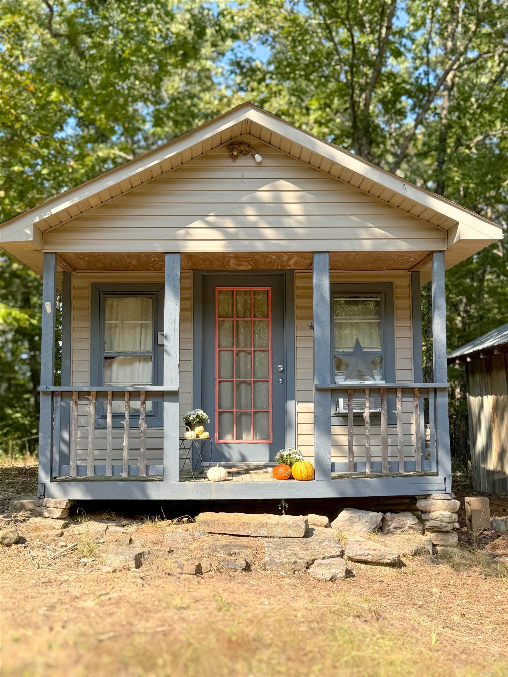 Excellent hunting property with a small hunting cabin and a storage barn approximately 10 minutes from Mountain View. Creek with small waterfalls you can see and hear from the porch. Leveled pad for another home, shop or parking. Deeded access along the power line to the red T post just before the cabin. Cabin has a window unit, propane heater, mini-fridge, brand new on-demand hot water heater, toilet, small kitchen island and futon couch. Perfect for a weekend getaway or hunting trip!