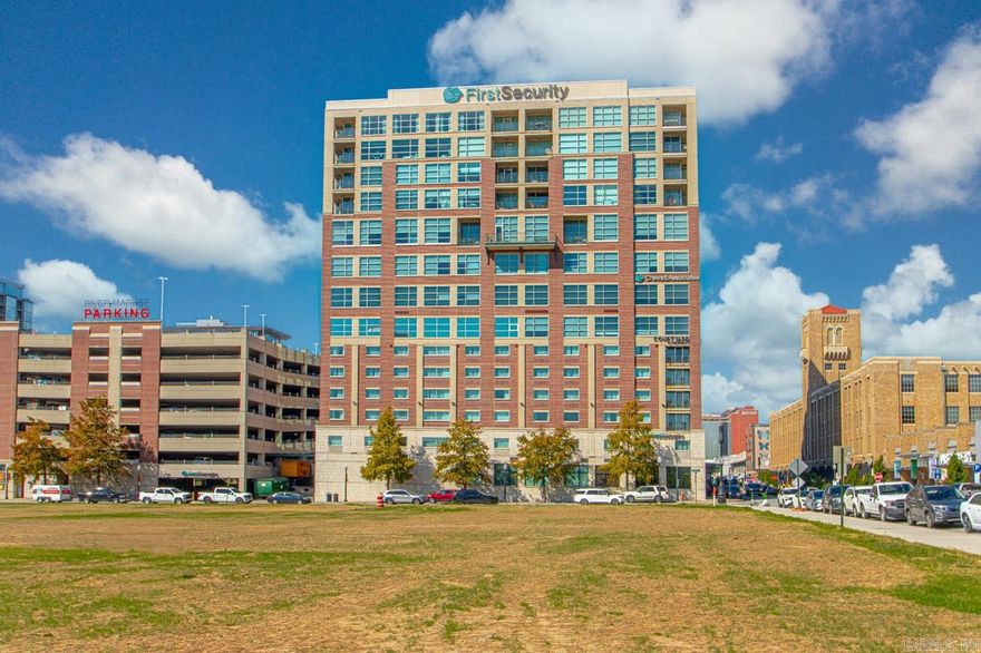 This beautiful high rise condo is located in the heart of Little Rock's vibrant downtown River Market District. SPECTACULAR views of the Arkansas River and downtown skyline from every room, this corner unit features high ceilings, floor to ceiling windows, 2 bedrooms, 2 baths, separate office, gas fireplace and offers a unique convenience to all areas of Little Rock. You will love being in the middle of the walkable River Market with all the entertainment & restaurants the district has to offer. Watch fireworks and listen to concerts from the wrap-around balcony facing the river. The Clinton Library is just a few blocks away, along with the new, hopping East Village area. This building offers a full-service hotel on the lower level for out of town guests featuring a Starbucks, Bar and Private Executive meeting room. The condo includes one secured parking space and plenty of nearby guest parking. See agent remarks for showings.