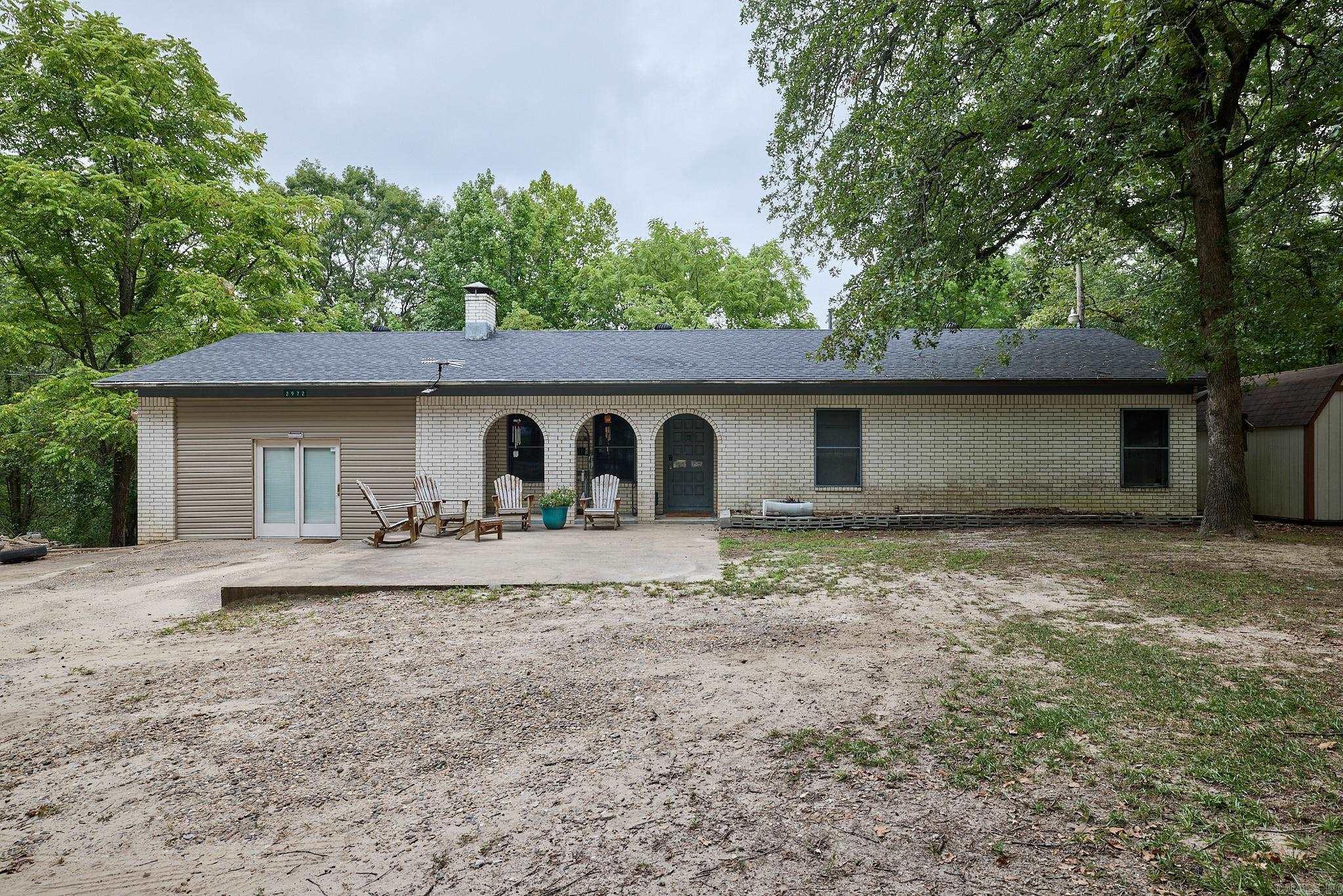 Welcome to this charming three-bedroom, two-bathroom country home conveniently located just off I-30. Situated on a spacious two-acre lot, this property boasts a 40' x 50' cinder block shop, complete with a storm shelter for added peace of mind. Additionally, there's an extra storage building located behind the home. Inside, you'll find numerous updates, including a new HVAC system installed in 2021 and all-new kitchen appliances added in December 2023. The kitchen features a gas stove that promises delightful cooking experiences for all. Recent upgrades also include new hardwood flooring, a cozy gas log insert, and a hot water tank replaced in 2023. Outside, the level yard offers plenty of space and potential for various outdoor activities. Whether you're looking for a peaceful country retreat or a place with room to grow, this property has it all.