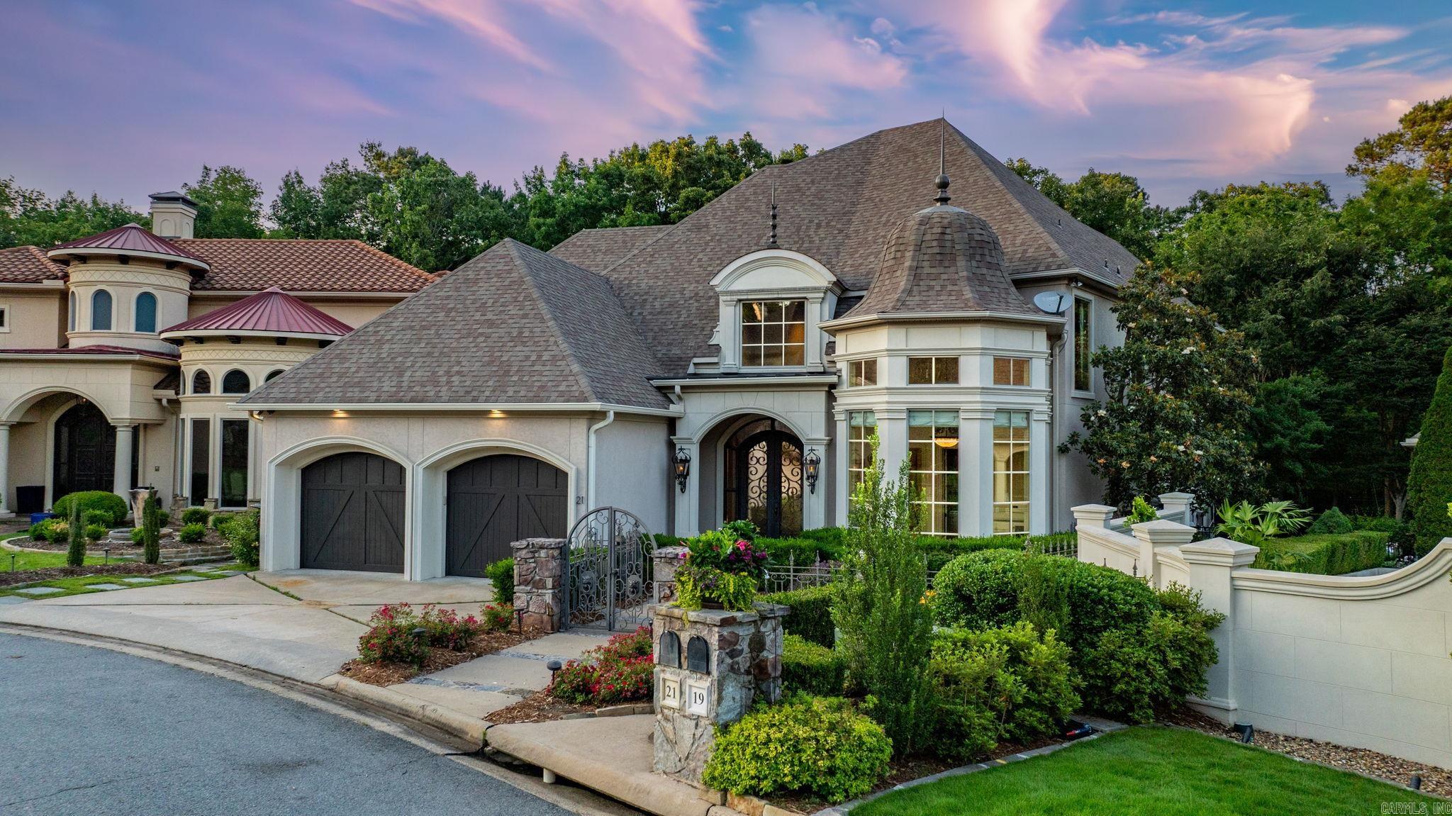 Welcome to this stunning residence in the sought-after LaScala area of the gated Hickory Grove community. Once a Symphony Designer House, this home is filled with custom details. Enter through a gated courtyard & covered front patio, where elegant iron doors lead into a grand foyer with soaring ceilings. The home’s open floor plan features tall ceilings & a light-filled living area with expansive windows overlooking backyard. The gourmet kitchen has premium appliances, a spacious island with storage & designer lighting. Adjacent to the kitchen is dining area, highlighted by a custom James Hayes chandelier, complemented by a piece in the nearby wet bar. The main level includes primary suite with a dream-worthy walk-in closet & luxurious marble bath featuring double vanities, soaking tub, & walk-in shower. Also on this floor is a bright, freshly painted office with ample storage, family room, half bath, & laundry for added convenience. Upstairs you’ll find a generous 2nd living area with wet bar, 2 ensuite bedrooms, & versatile third bedroom that could be a home gym. Additional highlights: extensive storage, Elan smart home sytm with 7 televisions that convey. Gorgeous outdoor areas!