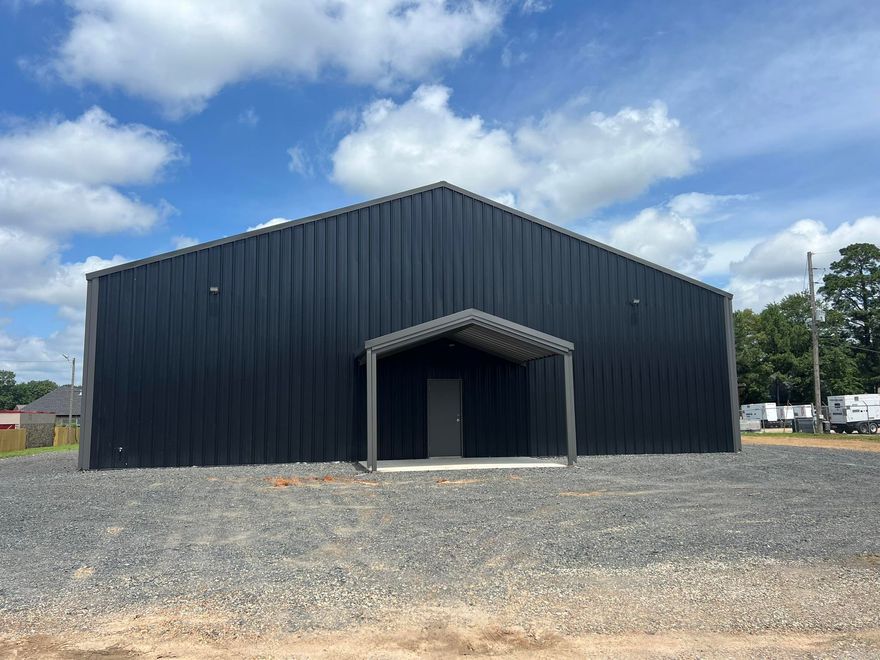 Brand new 60 X 80 METAL BUILDING w/ 60 x 20 awning on the back. Side walls are 15', center of rooms are 20'+ high. There is a center wall dividing the building into 2 separate sections. Double doors between the sections can be left opened or locked off for separate businesses. Each side has a 1/2 bath. The front side has an office space with floored storage above & a full staircase to the upstairs. Front office will have a mini-split unit for AC & Heat. Completely fenced w/ ornamental iron fence on the front & iron gate @entrance. There is a little finishing to do inside, bath rooms are not complete. They will have both have vanities & toilets. Tax figure is based on unimproved land since the building is brand new.Explanation for some Features: (S) Reason for selling: Built it to sell; (ZC) Wall type: Metal; (ZD) Sq footage source: Builder. Owner of the LLC is a licensed Realtor in Arkansas.