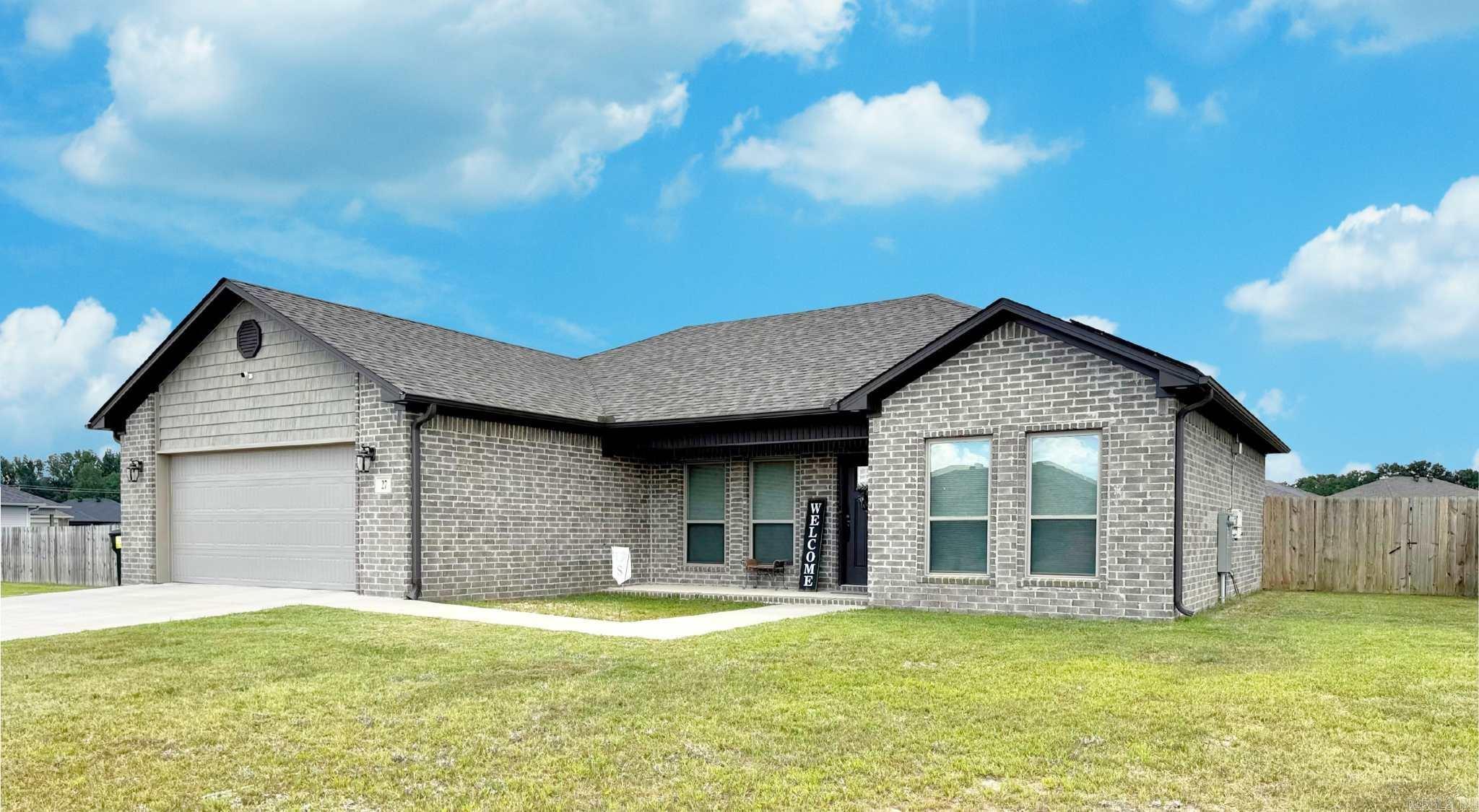 Embrace a vibrant lifestyle in this open concept three bedroom two bath home built in 2022. From the moment you arrive the covered front porch invites you to relax while the covered back patio promises endless afternoons in a fenced oversized yard. Inside the kitchen dazzles with a porcelain farmhouse sink granite counters stainless appliances and a walk in pantry. The living space flows with luxury vinyl plank flooring and the primary suite feels like a retreat with two roomy closets a tiled shower and double sinks. A large laundry room with storage gutters and solar panels add convenience and sustainability. Enjoy modern comfort and cheerful style agents to see remarks on solar panels.