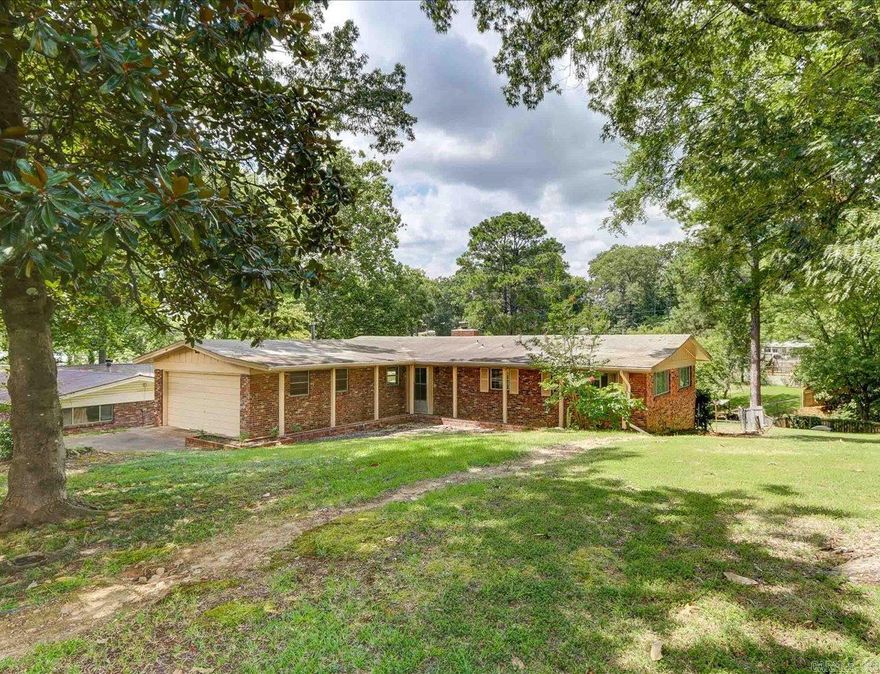 Furnished Lakefront home in quiet neighborhood. L-Shaped home with front entry garage and a wide front porch inviting you in to the beautiful living area with picture window views overlooking the large back yard and Lake Hamilton.   Very nice kitchen with ample storage, light and bright with a dine-in level breakfast bar between the living and kitchen. Countertop stove and built in oven.  Three oversized bedrooms, Master bath and Guest Bath, Laundry Room. Outside Living includes a large wood deck, backyard and covered fishing pier on the waterside.  Pull your boat along side for year-round enjoyment.  Protected cove ends past the home.