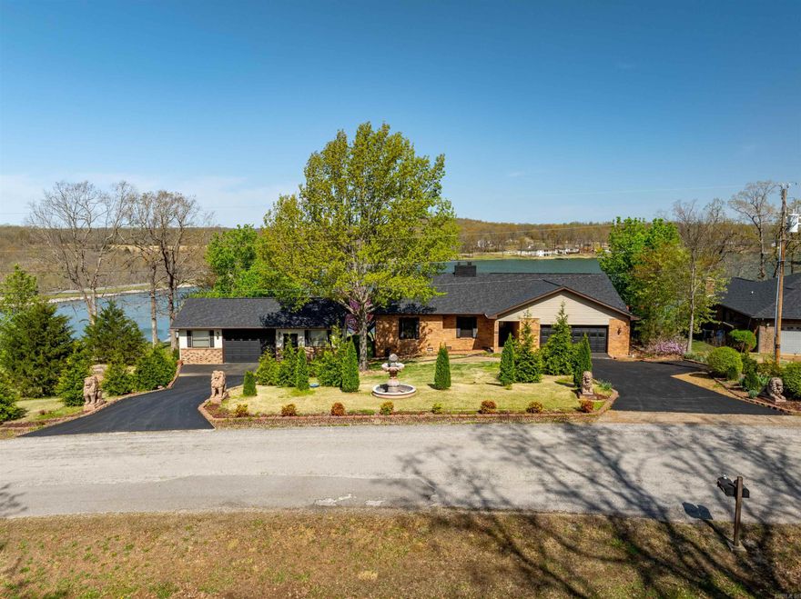 Incredible Crown Lake Home – Priced to Sell Quickly!  This stunning furnished home on Crown Lake is a true gem! With striking curb appeal including a fountain, lion statues, and extensive landscaping, it offers easy access via paved driveways to an attached 2-car garage and a detached 1-car garage/workshop. Inside, you’ll find gorgeous views of the lake through the sunroom, a spacious living area with a gas fireplace, and a kitchen with custom Knotty Alder cabinets, lighting above and below, a large island, pantry, and dining space with deck access. Dimmers are installed throughout to set the perfect mood.  The primary suite has a walk-in closet, custom tiled shower, and private deck access. Another bedroom and a full bath with a light-up mirror and walk-in shower round out the main level. Downstairs features a large open area with a wood stove, three bonus rooms, and walk-out access to a covered patio and your private, covered dock with room for two boats and a pontoon.  Enjoy excellent bass fishing and tournaments on Crown Lake, plus tubing and skiing with the kids.With about 2,100 sq ft on main level and 1,200 in basement.