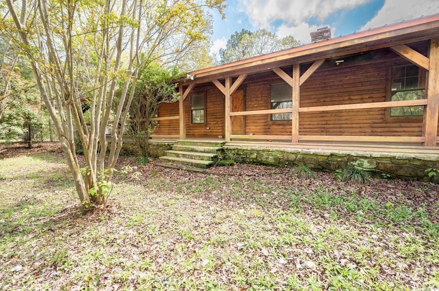 Fantastic authentic log home on 11.3 acres. Douglas fir ext w/ wrap around porch on 3 sides. Vaulted ceilings, solid wood beams, interior walls tongue & groove Douglas fir; site built hardwoods throughout. Large greatrm w/ FP opens to kitchen. Kitchen w/ cook island & breakfast bar.3BRs/2BAs w/split master suite w/ jetted tub&sep shower5 yrold metal roof.3stall barn & tack rm,riding arena.Stand-by Generator Potential to develop single family subdivision. New home builds adjacent to property - Roman Heights.