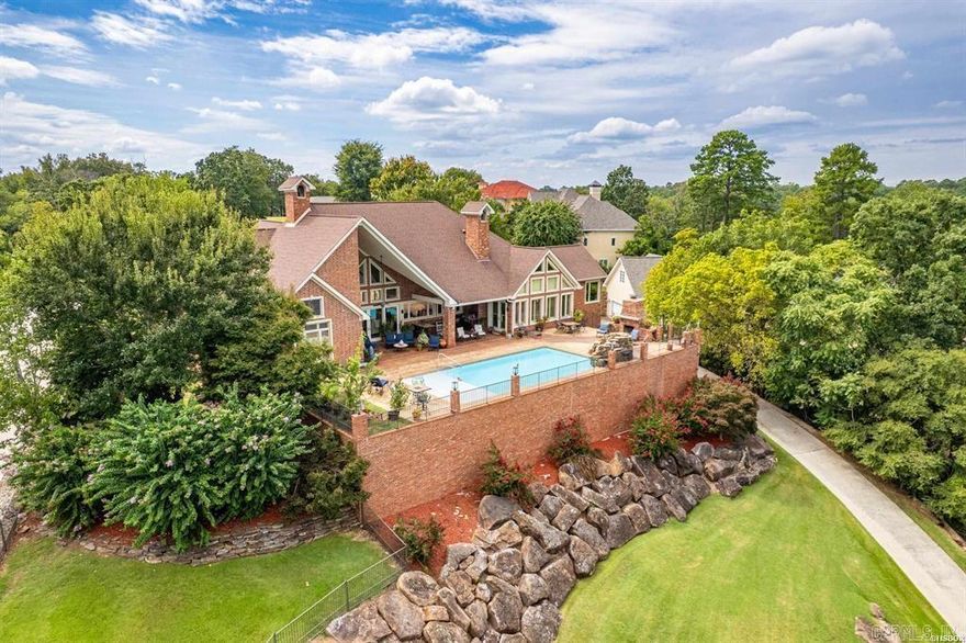 Welcome to your dream home retreat on beautiful Lake Hamilton where luxury and comfort come together in all the best ways. With 6008 square feet, this beauty offers 4 spacious bedrooms, 5.5 baths, and a bonus room that is perfect for a theater, music room or even a 5th bedroom.  Step inside and you'll find soaring ceilings, crystal chandeliers, a cozy fireplace, floor to ceiling windows, iconic columns, magnificent kitchen with ice maker, wine fridge, massive double sized fridge freezer combination, all creating the perfect open space for entertaining or relaxing as you take in the unmatched views of Lake Hamilton and the mountains surrounding Hot Springs.  As you step outside to the sparkling pool to prepare food in the outdoor kitchen, your guests can further enjoy the easy walk down to your 2 stall covered boat slips for a getaway across Lake Hamilton.  Conveniently located close to restaurants, shopping and all the conveniences of town, yet tucked away from all the hustle and bustle, this home has it all when it comes to enjoying lake living.  Come partake in your destiny on the water in historic Hot Springs, AR, the Spa City, home of America's first National Park.