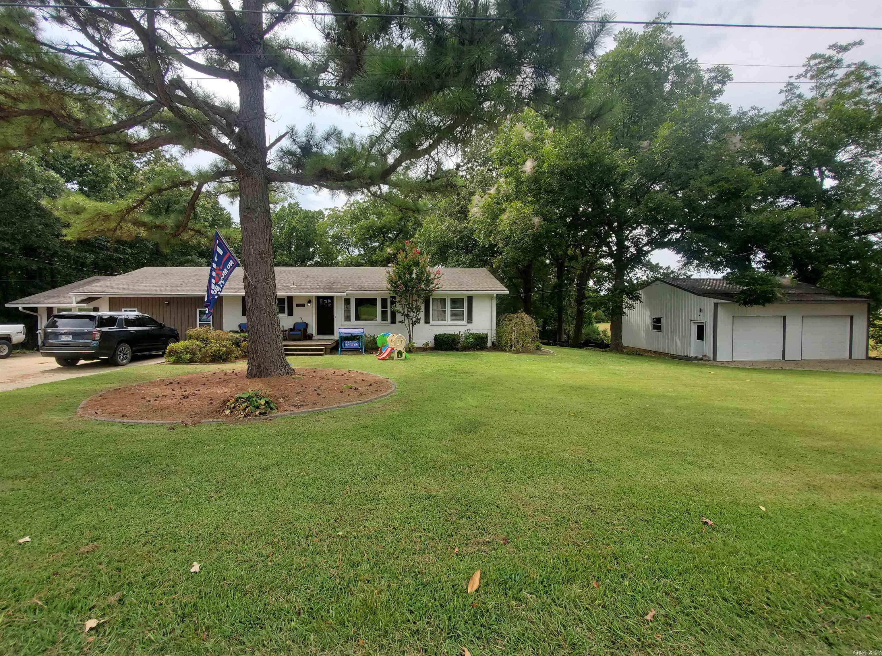 Welcome to 1252 N 4th Avenue in Piggott, AR. Discover this beautifully updated 4-bedroom, 2-bath residence in a peaceful neighborhood on nearly half an acre. A bright, open-concept floor plan flows through living, dining, and kitchen areas, featuring stylish LVP floors, crown molding, and modern lighting. The gourmet kitchen boasts a spacious island, stainless appliances, oversized sink, and chic tile backsplash. The deck off the living space invites you to unwind or entertain while enjoying tranquil sunset views. Downstairs, an unfinished basement awaits transformation to suit your needs. The large family room is perfect for gatherings. For creators or car enthusiasts, the expansive 30?Ć?30 shop adds versatility. With a brick exterior, and all the comforts of central heating and cooling, this home is move-in ready and designed for modern lifestyles.