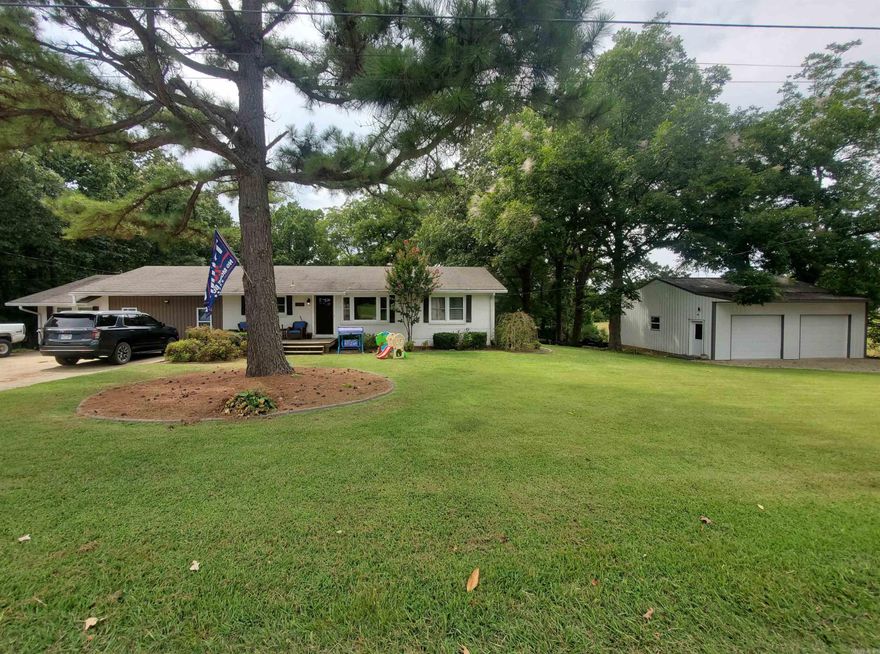 Welcome to 1252 N 4th Avenue in Piggott, AR. Discover this beautifully updated 4-bedroom, 2-bath residence in a peaceful neighborhood on nearly half an acre. A bright, open-concept floor plan flows through living, dining, and kitchen areas, featuring stylish LVP floors, crown molding, and modern lighting. The gourmet kitchen boasts a spacious island, stainless appliances, oversized sink, and chic tile backsplash. The deck off the living space invites you to unwind or entertain while enjoying tranquil sunset views. Downstairs, an unfinished basement awaits transformation to suit your needs. The large family room is perfect for gatherings. For creators or car enthusiasts, the expansive 30x30 shop adds versatility. With a brick exterior, and all the comforts of central heating and cooling, this home is move-in ready and designed for modern lifestyles.