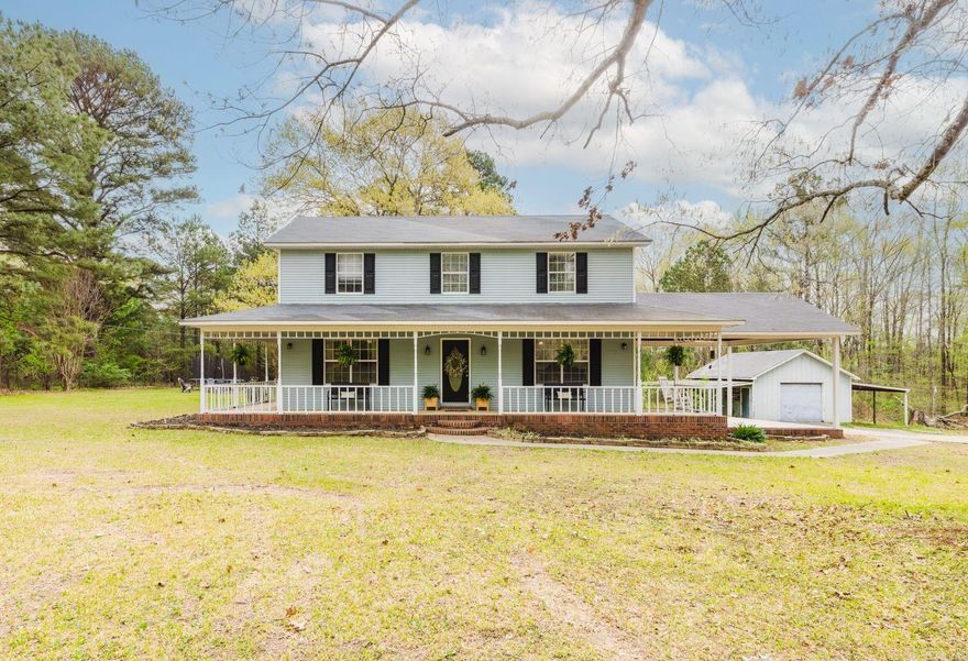 This beautiful two-story home sits on 1.5 acres in the heart of town, offering the perfect mix of privacy and convenience. Featuring 3 bedrooms and 2.5 bathrooms, the home is spacious and inviting. The highlight is the expansive wrap-around porch, ideal for relaxing and enjoying the peaceful surroundings.  Inside, you will find a cozy living room and a well-equipped kitchen with plenty of counter and storage space. The master suite boasts a private en-suite bathroom, while two additional bedrooms offer ample space for family or guests.  The property also includes a large storage barn, perfect for tools, equipment, or even a workshop. The 1.5-acre lot offers plenty of room for outdoor activities, gardening, or future expansions.  Located close to schools, shopping, and other town amenities, this home is a true gem. Don't miss your chance to own this charming property in a prime location.