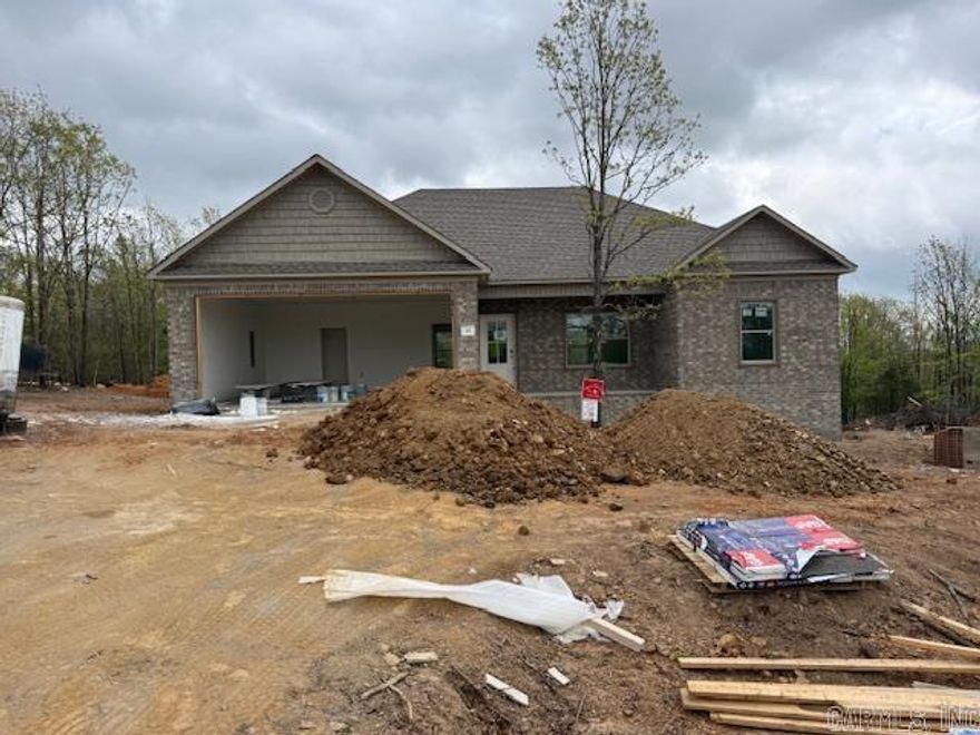 New construction home in progress offering modern design and quality craftsmanship! This brick home features a spacious open-concept layout with a large living area that flows into the kitchen and dining space—perfect for entertaining and everyday living. The kitchen is being outfitted with custom cabinetry, a center island, and ample workspace.  The primary suite is designed to include a private bath with a walk-in shower and stylish finishes, along with a generous closet. Additional bedrooms provide flexibility for guests, family, or a home office.  Situated on a private, wooded lot, this property offers peaceful surroundings and room to enjoy the outdoors. With a two-car garage and thoughtful layout, this home combines comfort and functionality.