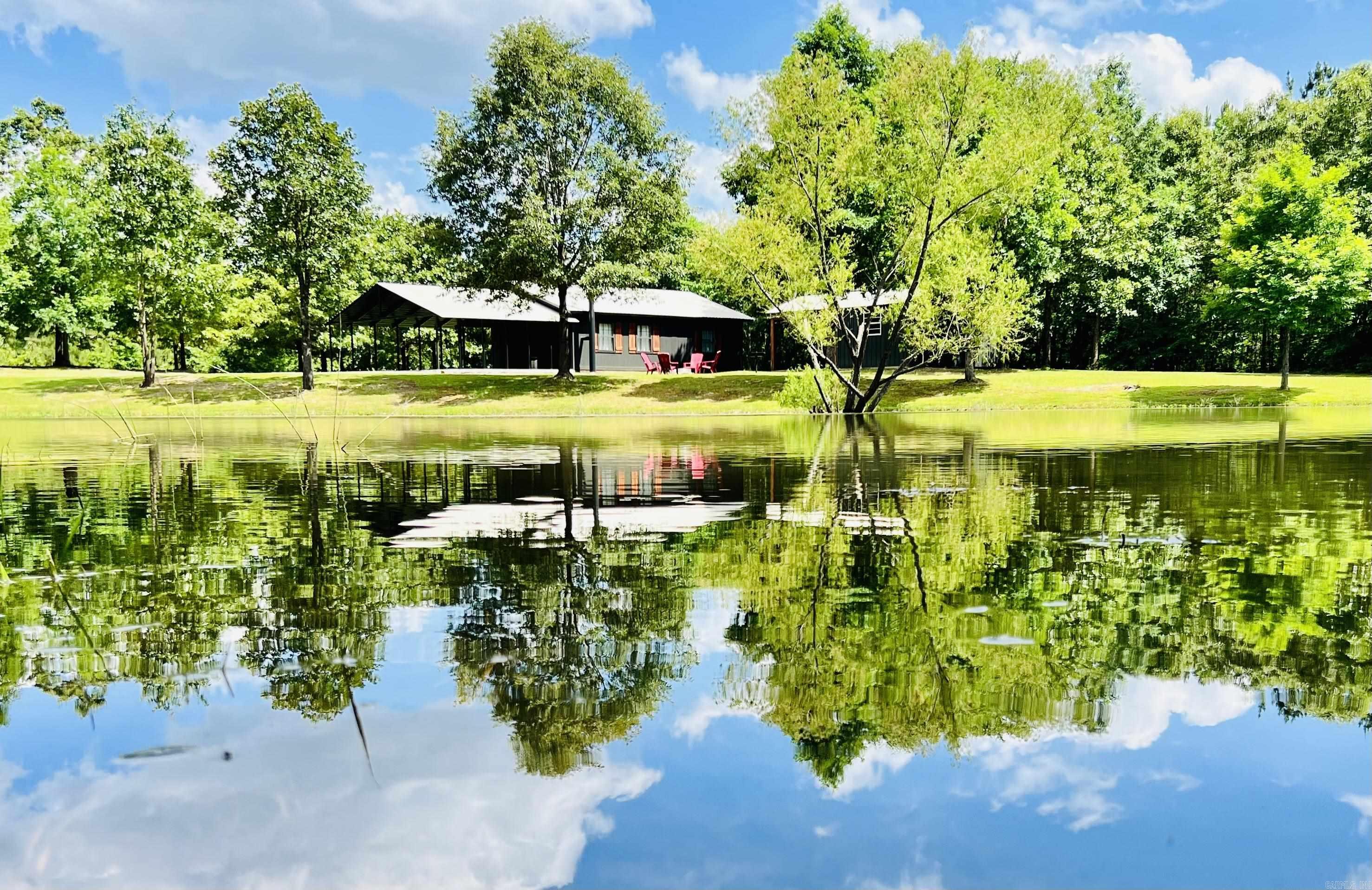 An amazing in-come producing property! This 936 sq ft. Very well maintained cabin offers 1 bed, 1 large bath with a utility room, tile flooring though out, outdoor shop with patio, Large 2 car carport, and a fire ring. If you love fishing and outdoors and want to unwind while soaking up the surroundings there is a stocked pond. Built in 2007 with great rental history, this property comes fully furnished and ready for business. Not far from Cowhide Cove campgrounds. Please call today for your appointment. Perfect AIR B&B / VRBO