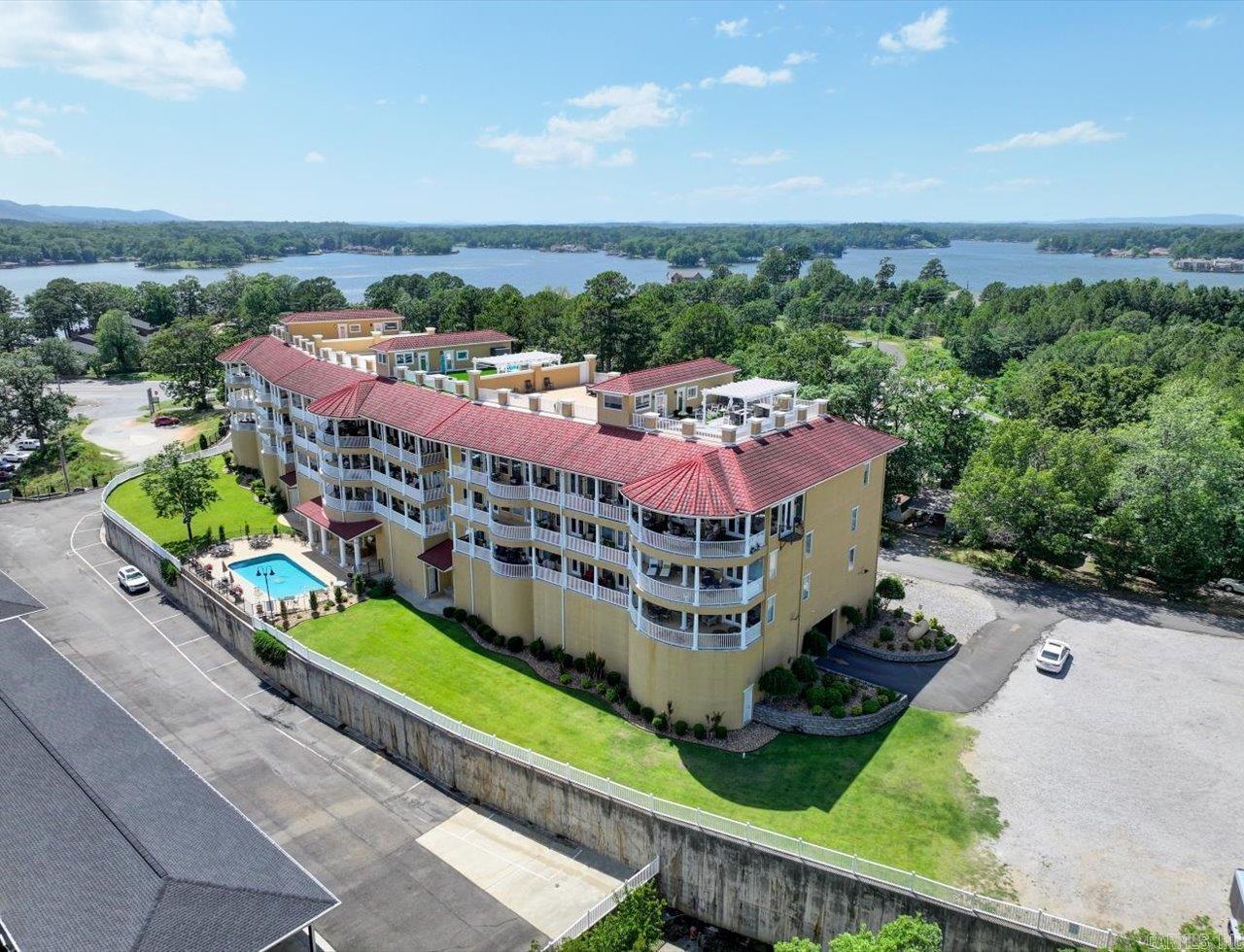 This luxurious lakefront condo on St John's Island offers breathtaking 180-degree views of Lake Hamilton and an unparalleled lifestyle. Wake up to stunning vistas, relax on your private balcony overlooking the shimmering lake, and enjoy easy access to Hot Springsā vibrant amenities. More than a condo, itās a statement of refined taste and sophisticated living with indoor and outdoor entertaining spaces. Natural light floods the space through large windows and a private balcony. High-end finishes include stainless steel appliances, granite countertops, travertine floors, and upscale fixtures. The Private Master Suite features a luxurious bath, walk-in closet with built-in dressing area, and new marble tile. Two oversized bedrooms each have walk-in closets and en-suite baths with upgraded showers. The penthouse rooftop offers an enclosed private kitchen & bar, guest bath, and a deck with gazebo, multiple seating, dining areas, and 360-degree views. Recent upgrades include a roof replaced two years ago. A large storage unit leased for $75/month may transfer. Perfect for vacation or full-time living in luxury. Want me to tweak it more?