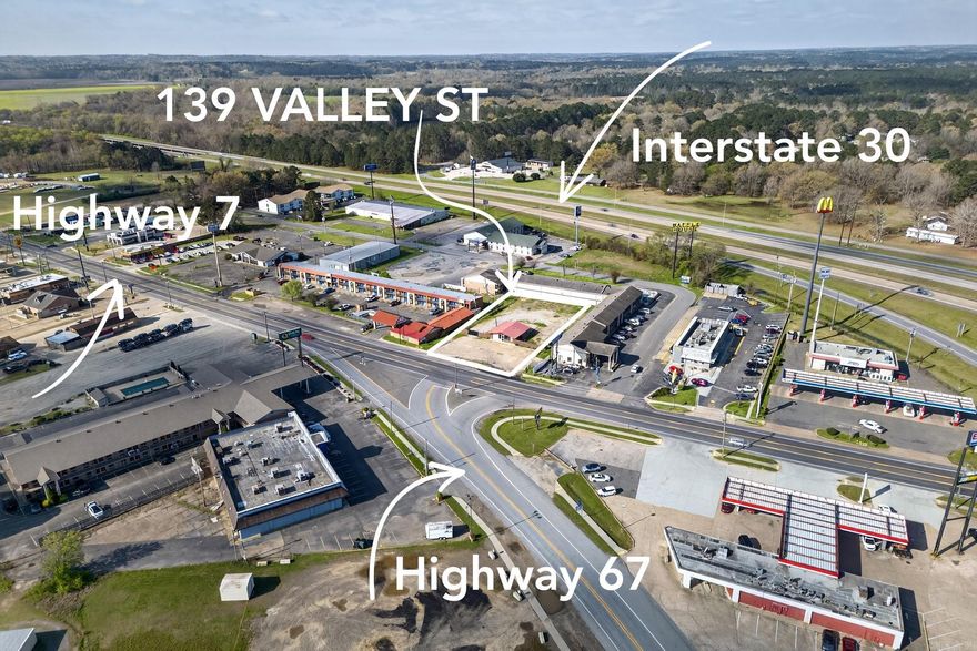 Prime commercial development opportunity located along one of Arkadelphia’s most highly traveled corridors, offering outstanding visibility and consistent drive-by exposure. With an estimated daily traffic count of approximately 34,000–35,000 vehicles and a significant percentage of truck traffic, this location is ideally positioned to support high-volume quick-service concepts such as drive-thru coffee, fast-casual dining, convenience retail, or service-oriented businesses seeking strong highway presence. The property benefits from steady regional commuter patterns and pass-through travel, helping capture morning, lunch, and evening traffic peaks. Its strategic positioning provides convenient access for customers while maximizing brand recognition and signage potential. Surrounded by established residential neighborhoods, local employers, and continued commercial growth, the site offers a reliable and expanding customer base. This is a rare opportunity for national or regional chains to secure a presence in a proven high-traffic location with long-term development potential in the Arkadelphia market.