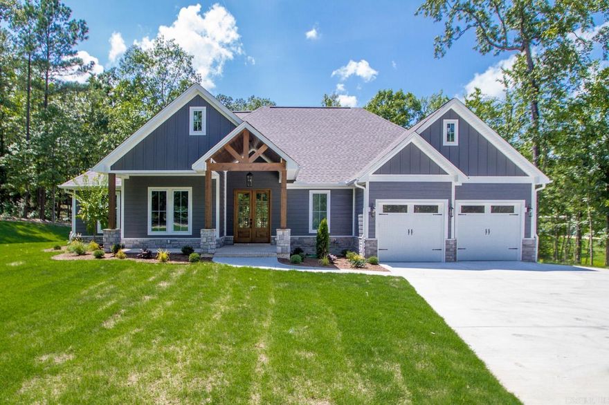 Indulge in the epitome of luxury living with this beautiful, traditional-style home, a true gem awaiting its new owners. Discover the comfort & elegance within its split floor plan, boasting four spacious bedrooms & two lavishly appointed bathrooms. Entertain in style in the expansive open-concept kitchen & living area, adorned with soft-close cabinets, a spice cabinet, & a grand walk-in pantry. Delight in culinary pursuits with a gas range & double oven, while evenings are made magical by the woodburning fireplace. Immerse yourself in natural light streaming through the abundant oversized windows. Retreat to the primary suite featuring wooden tray ceilings, while the ensuite bathroom is a sanctuary of relaxation, boasting a luxurious soaker tub nestled within a walk-in tile shower, double vanities, & a spacious walk-in closet conveniently connected to the laundry room. Generously sized spare bedrooms offer ample closet space, while the spare bathroom exudes sophistication with a double vanity & full tile surround shower. Outdoor bliss awaits on the expansive 3-acre wooded lot, complete with a 22KW Generac generator & a storm shelter, ensuring both luxury & safety in every aspect.