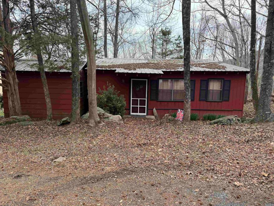 Enjoy lake life in this charming 3-bedroom, 2-bath rustic cabin with beautiful views of the water. Come put your own ideas to work in this cabin that comfortably sleeps 8 or more guests, featuring spacious bedrooms including one room with bunk beds that’s perfect for kids or larger groups.  Cabin includes a private two-stall boat dock, making it easy to spend your days fishing, boating, or relaxing on the lake. The dock is conveniently located just behind the home along the private drive in a shared common area.  Whether you're looking for a peaceful weekend getaway or a place for family and friends to gather, this cozy lakeside cabin offers the perfect blend of comfort, scenery, and outdoor fun.