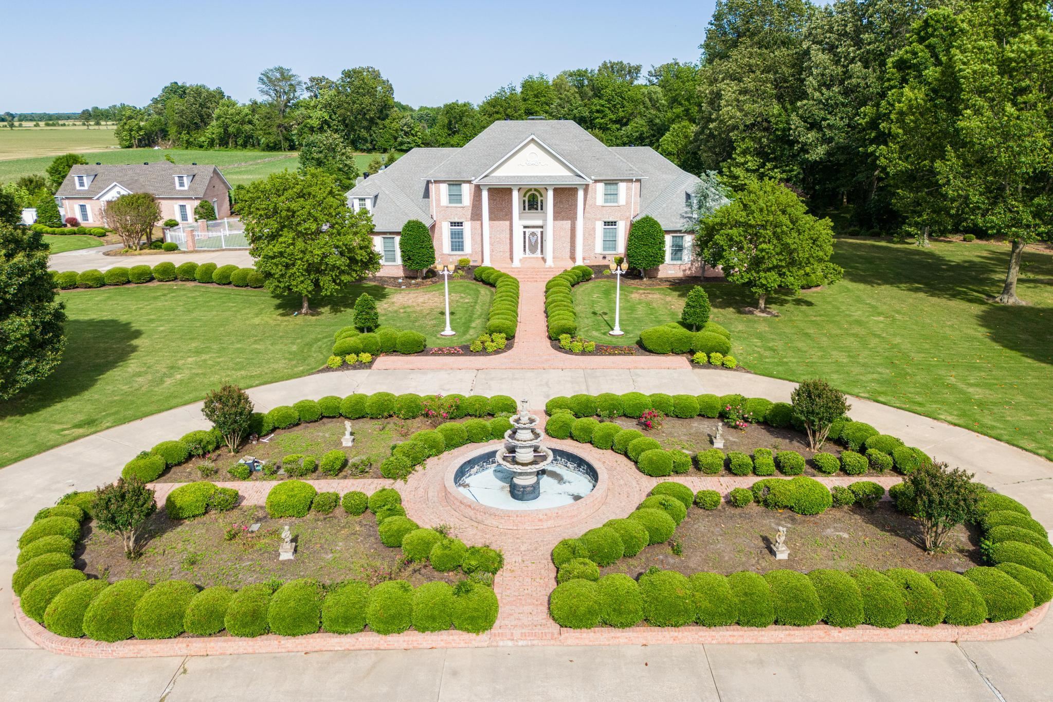 Welcome to your private sanctuary on nearly 16 acres of manicured land. This impressive 4-bedroom, 5 full and 2 half-bath estate offers spacious living with some fresh paint and thoughtful details throughout. Enter through the gated iron and brick entry to lush landscaping and a beautiful fountain. Inside, the chefās kitchen features granite countertops, high-end appliances, and a gas range with built-in griddle, opening to a large dining area, breakfast nook, and sunroom filled with natural light and backyard views. The primary suite is a true retreat with a vaulted sunroom, cozy gas fireplace, double closets, and relaxing en-suite bath. Each bedroom has its own bath for family or guests. A roomy office or den adds flexibility. Outside, enjoy a large deck, gazebo, and landscaped gardens perfect for dining or relaxing. A spacious shop with a three-car garage adds extra space for hobbies or work. Peaceful and private, yet convenient to the 412 Bypass!